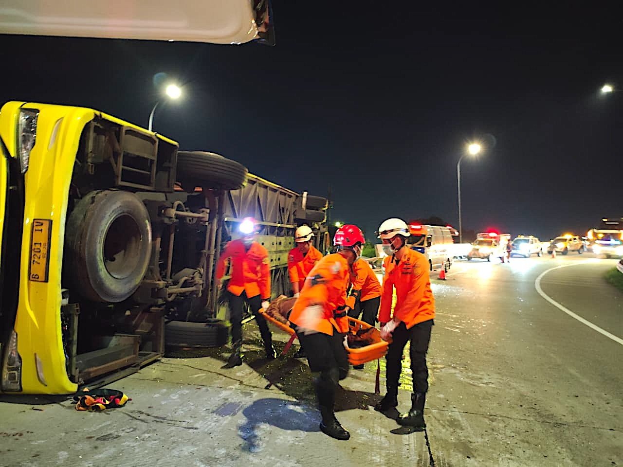 Rescuers carry a survivor from the wreckage of a crashed bus in Semarang, Central Java, on Monday. Photo: Basarnas/EPA