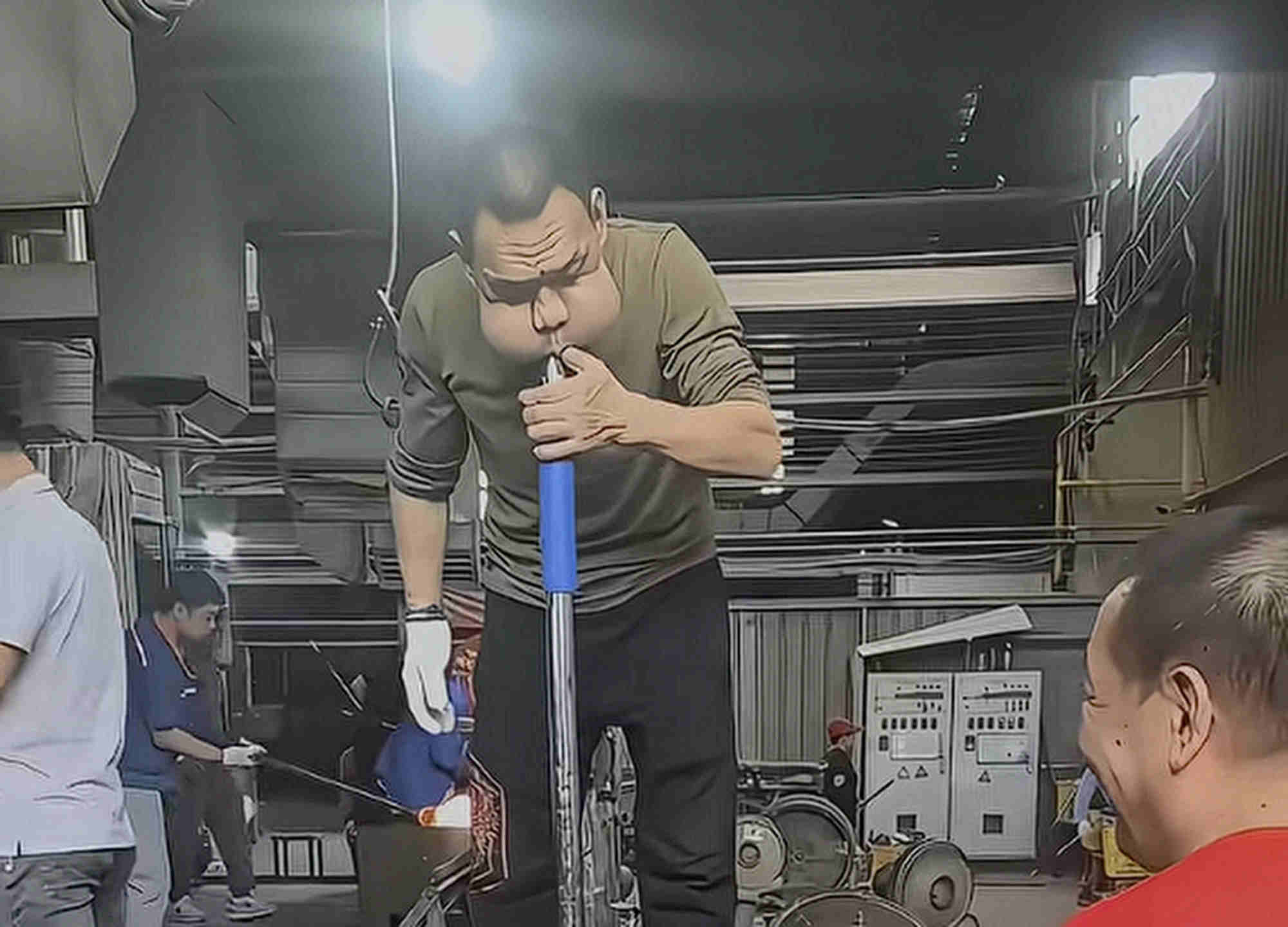 Zhang’s cheeks puff out as he gets down to work blowing on melted glass. Photo: Sina Zhang’s cheeks puff out as he gets down to work blowing on melted glass. Photo: Sina