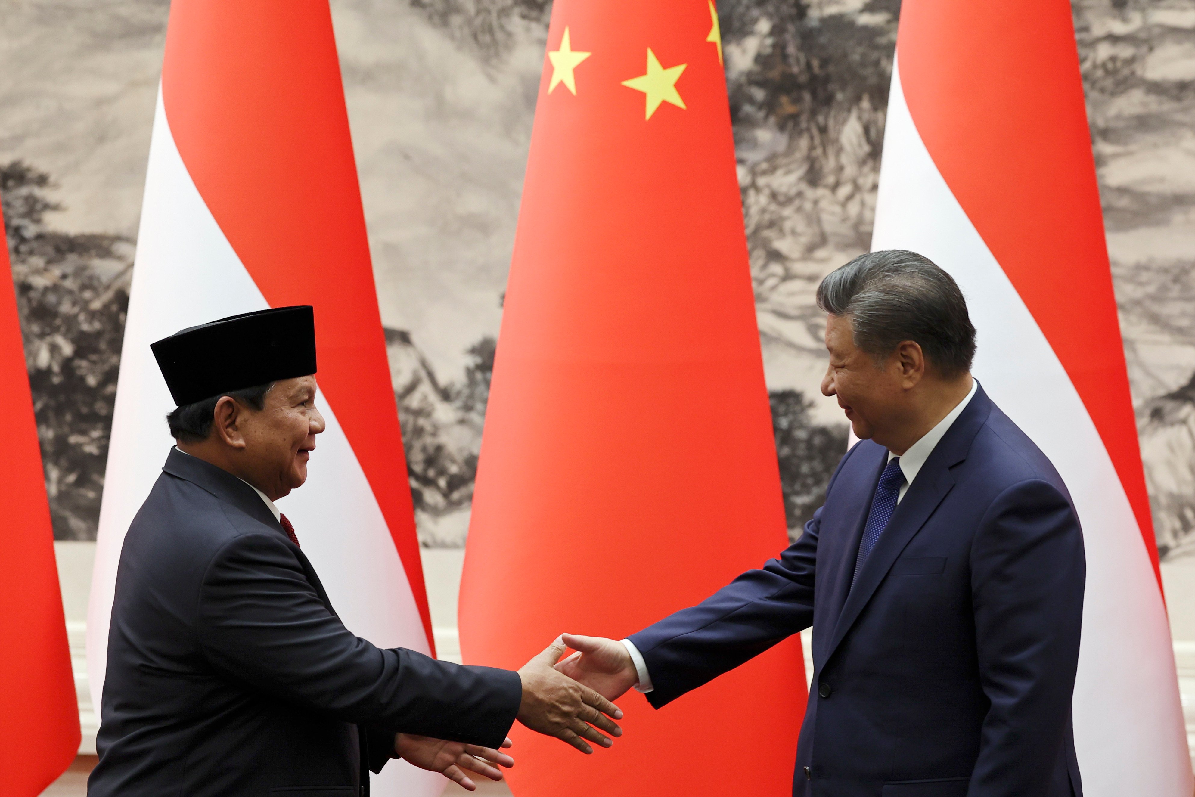 Indonesian President Prabowo Subianto and his Chinese counterpart Xi Jinping shake hands during their meeting at the Great Hall of the People, in Beijing, in November 2024. Prabowo is seen as “close” to Xi in a new survey. Photo: Pool via AP