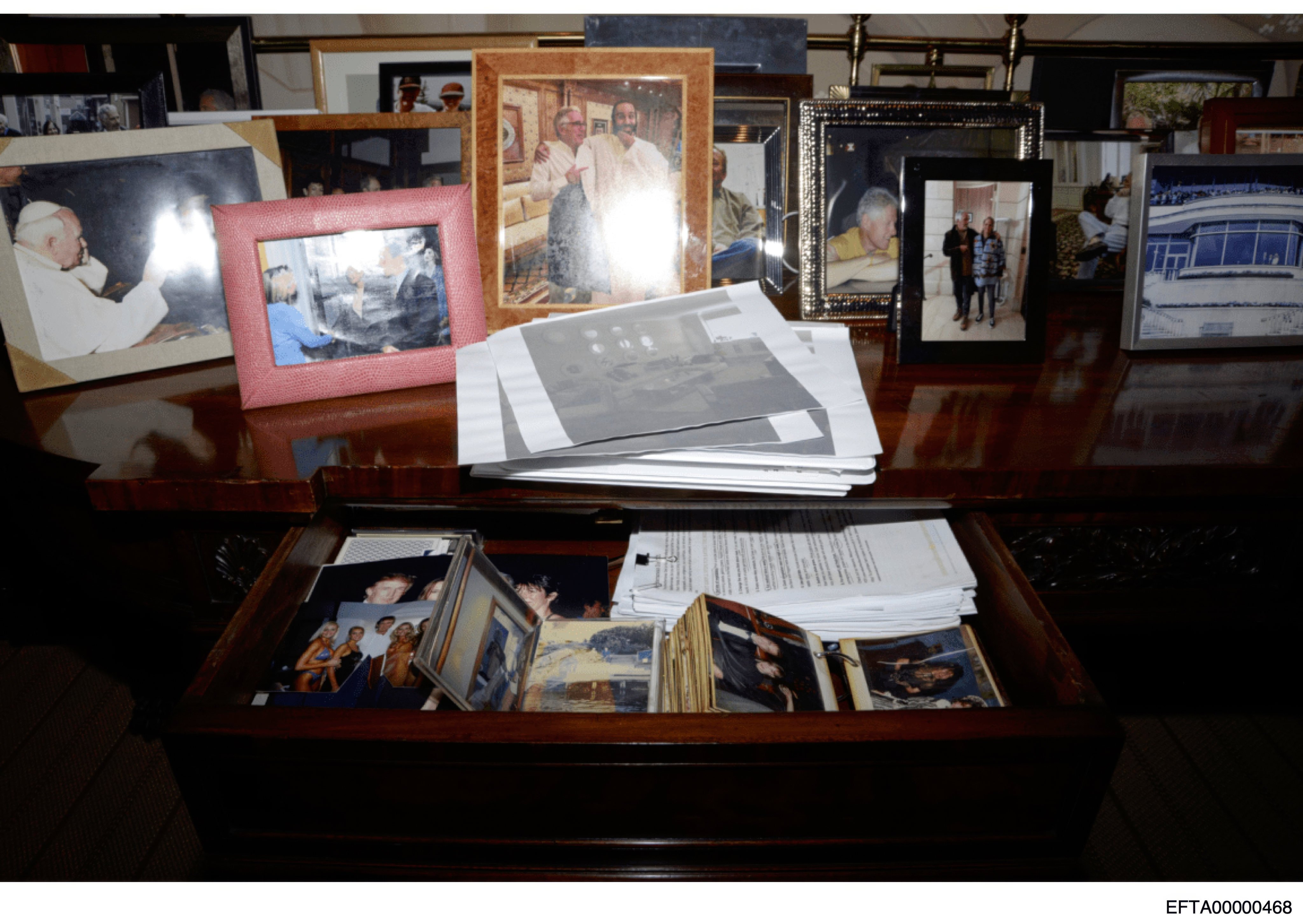 This photo released by the US Department of Justice shows a desk with a drawer open and photographs, documented in 2019, during a search of Jeffrey Epstein’s home in New York. Photo: US Department of Justice via AP