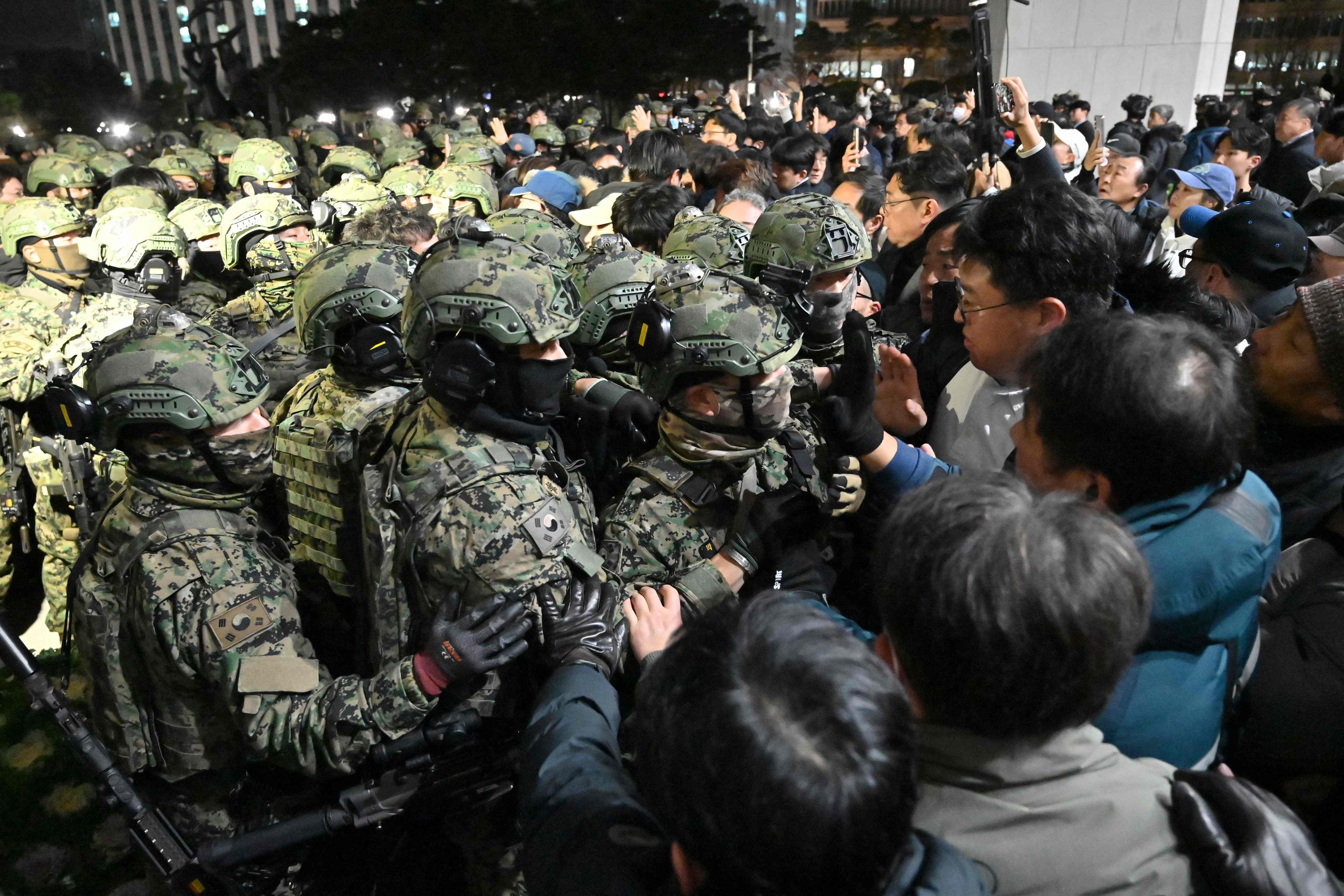 Soldiers try to enter the National Assembly building in Seoul, after then South Korea president Yoon Suk-yeol declared martial law on December 3, 2024. Photo: AFP