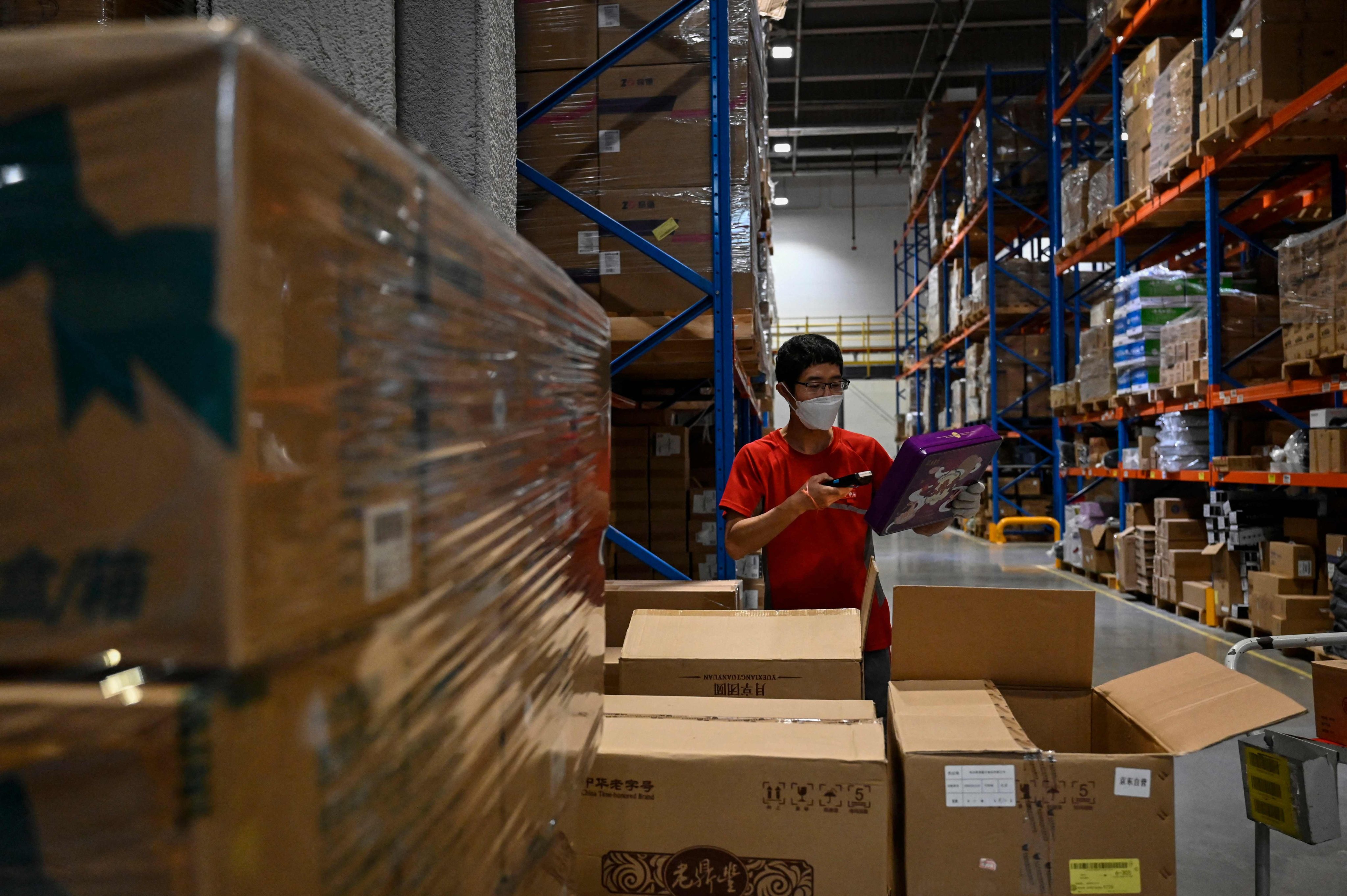 A worker sorts packages for delivery at a JD.com warehouse in Beijing. Photo: AFP