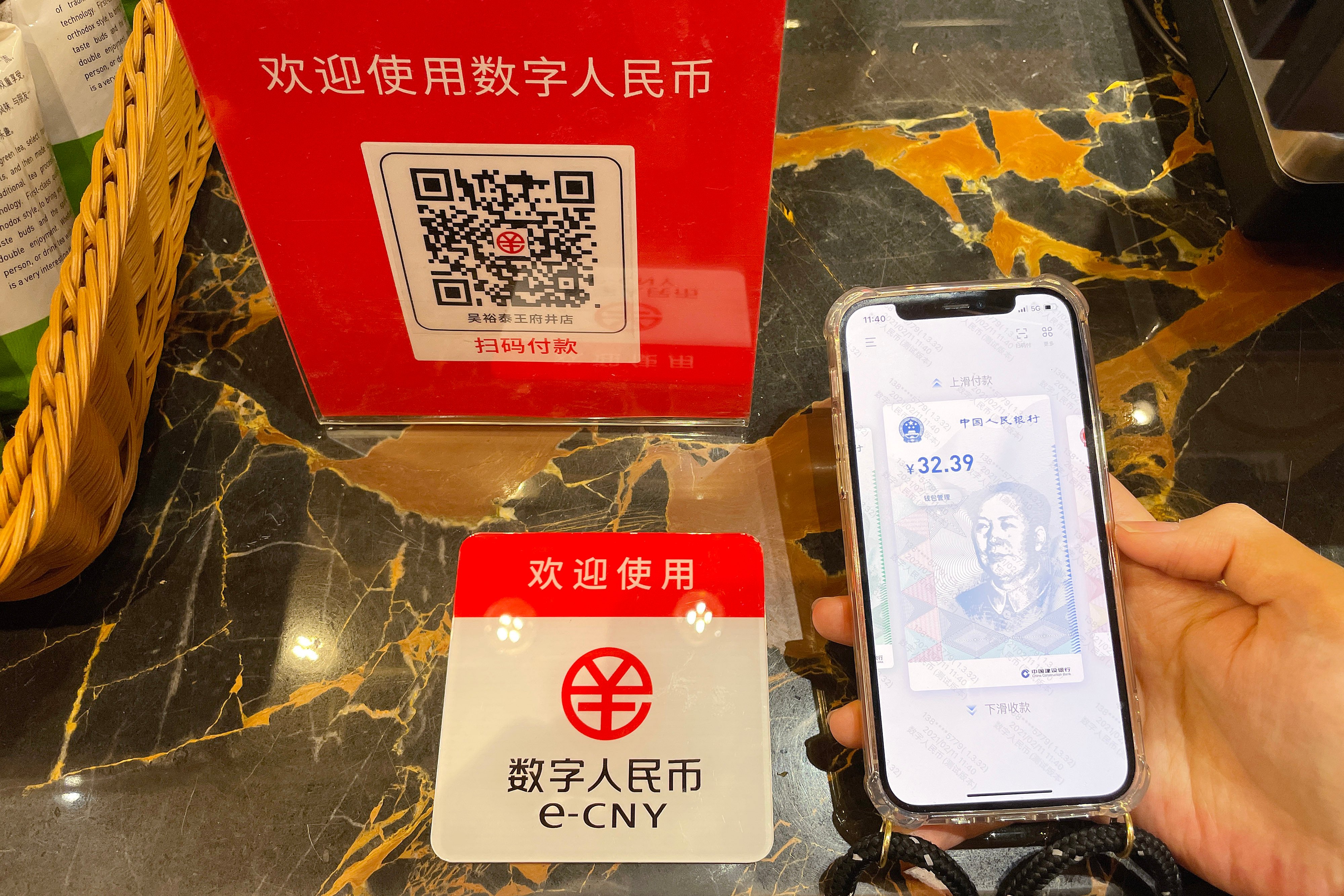 A customer makes a payment using China’s digital currency, or e-CNY, at a store in Beijing. Photo: Getty Images