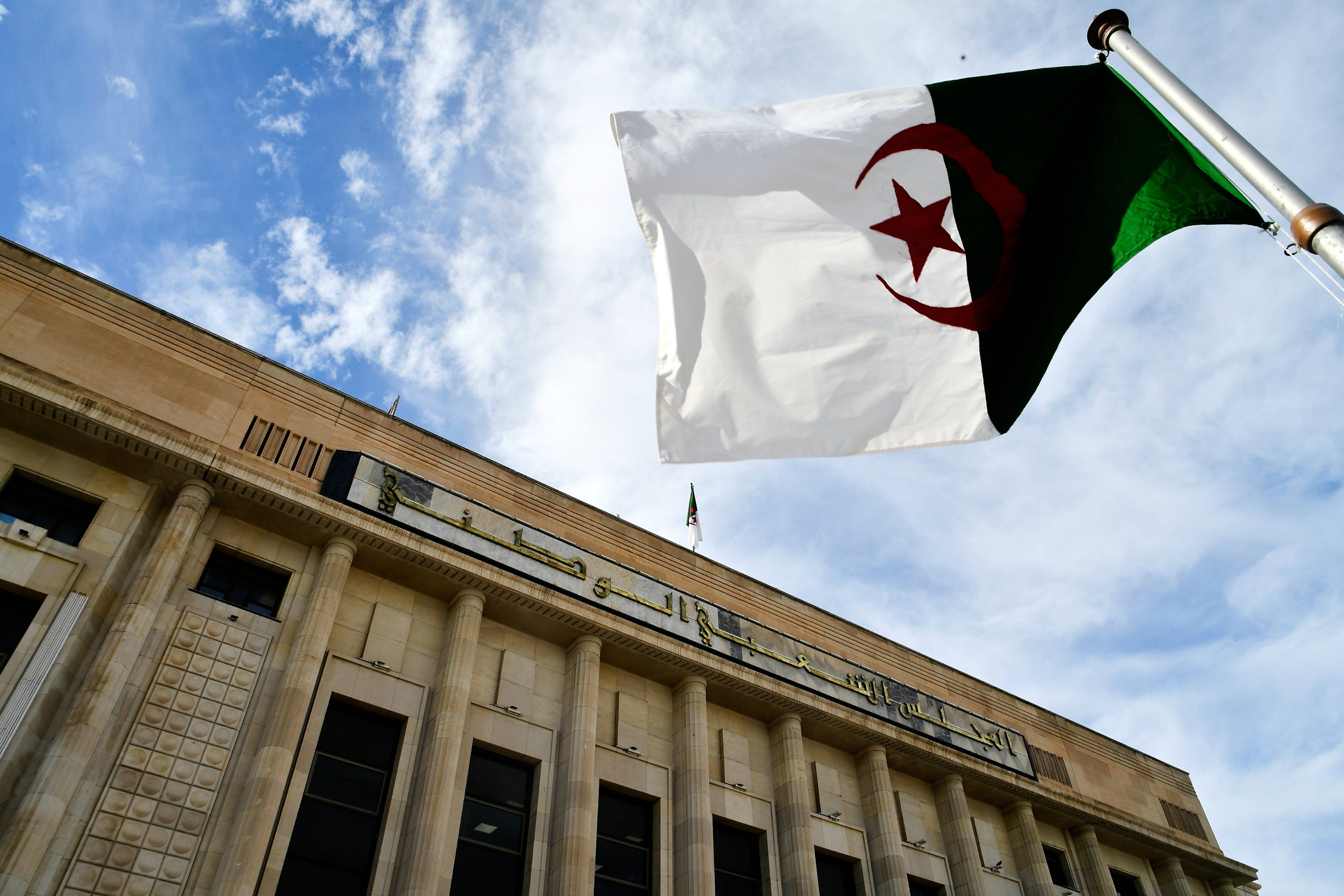 The Algerian flag flies outside the National Assembly as parliament members vote on a bill seeking to criminalise France’s colonisation. Photo: AP