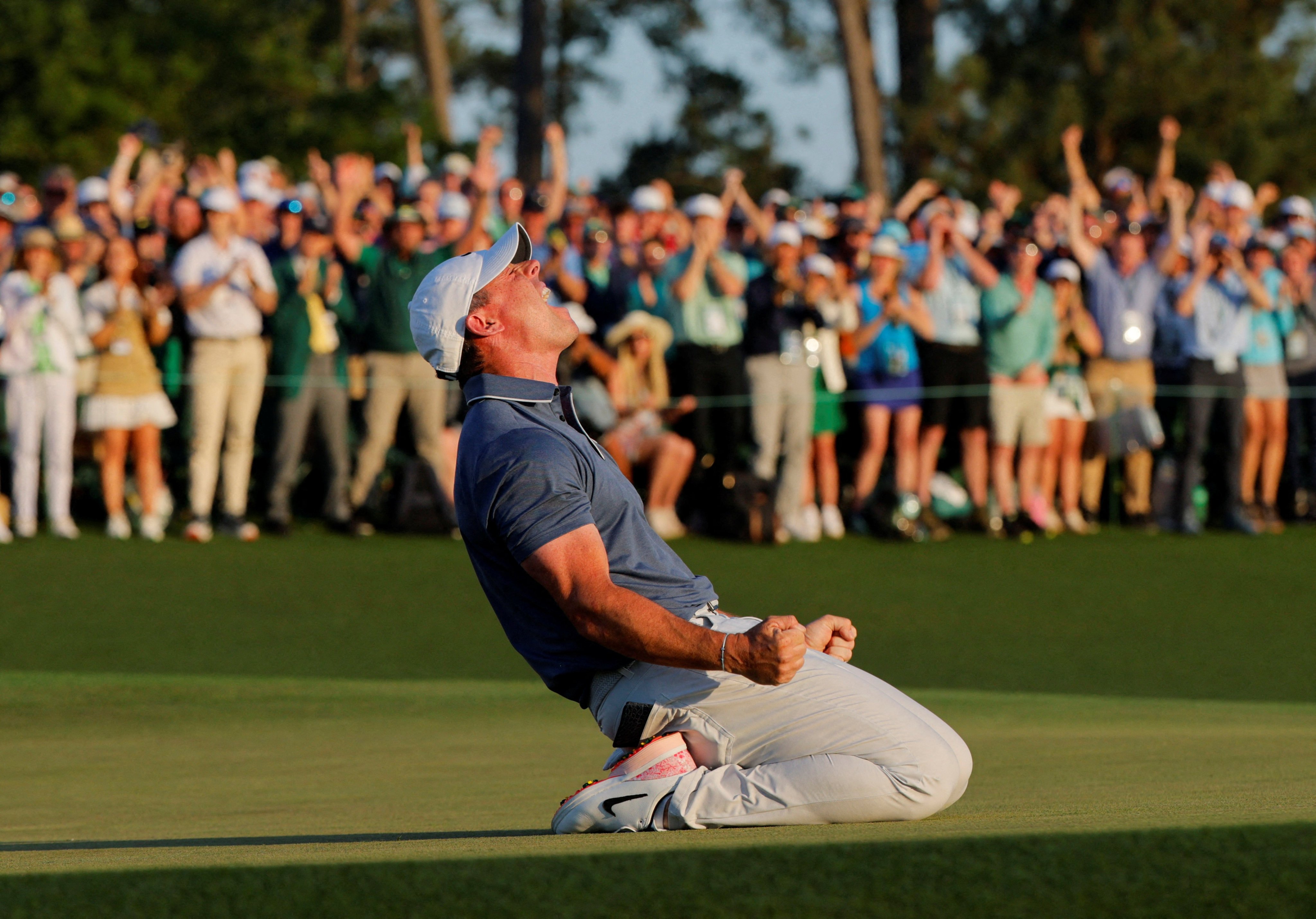 Northern Ireland’s Rory McIlroy celebrates with relief on the 18th green and 1st play-off hole after winning the US Masters and completing a career grand slam. Photo: Reuters