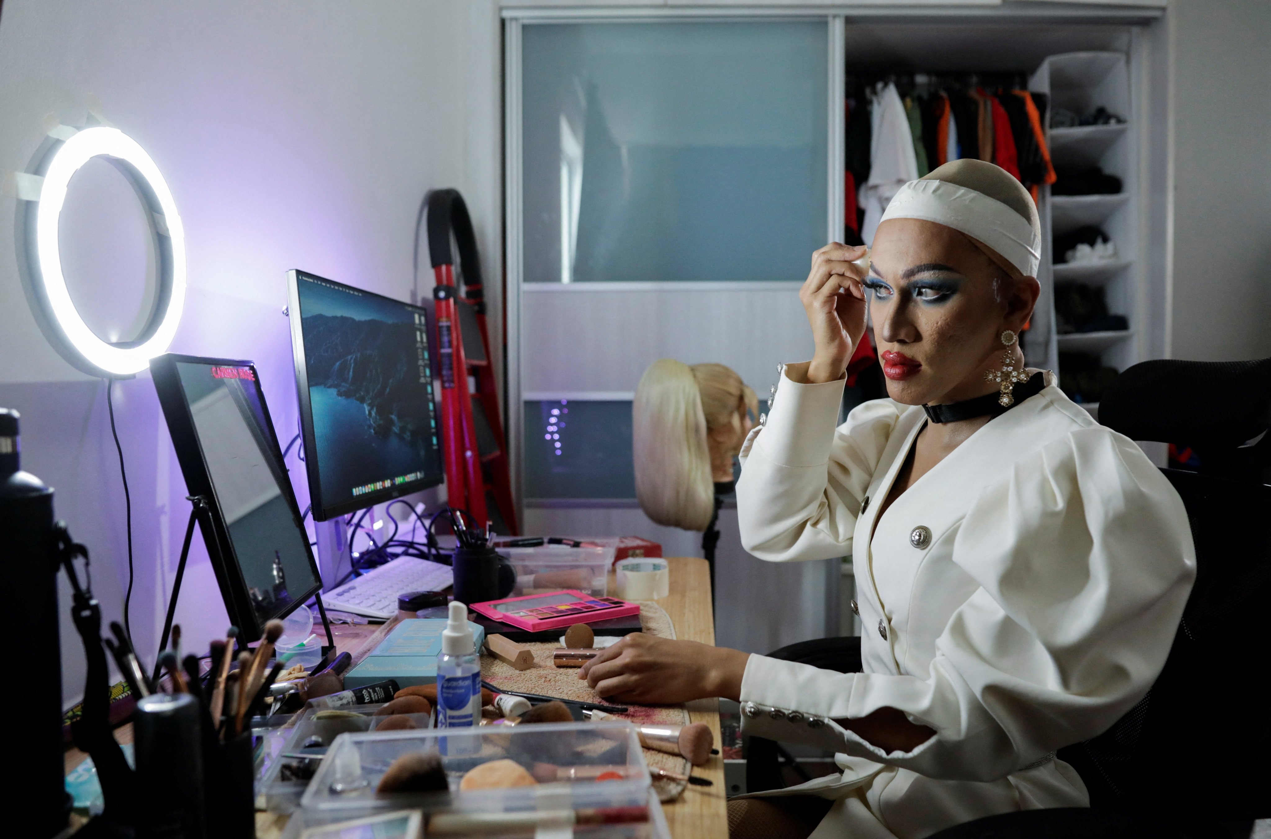 Malaysian drag queen Carmen Rose, who declined to disclose her non-drag identity due to fears of reprisal, puts on make-up. Photo: Reuters