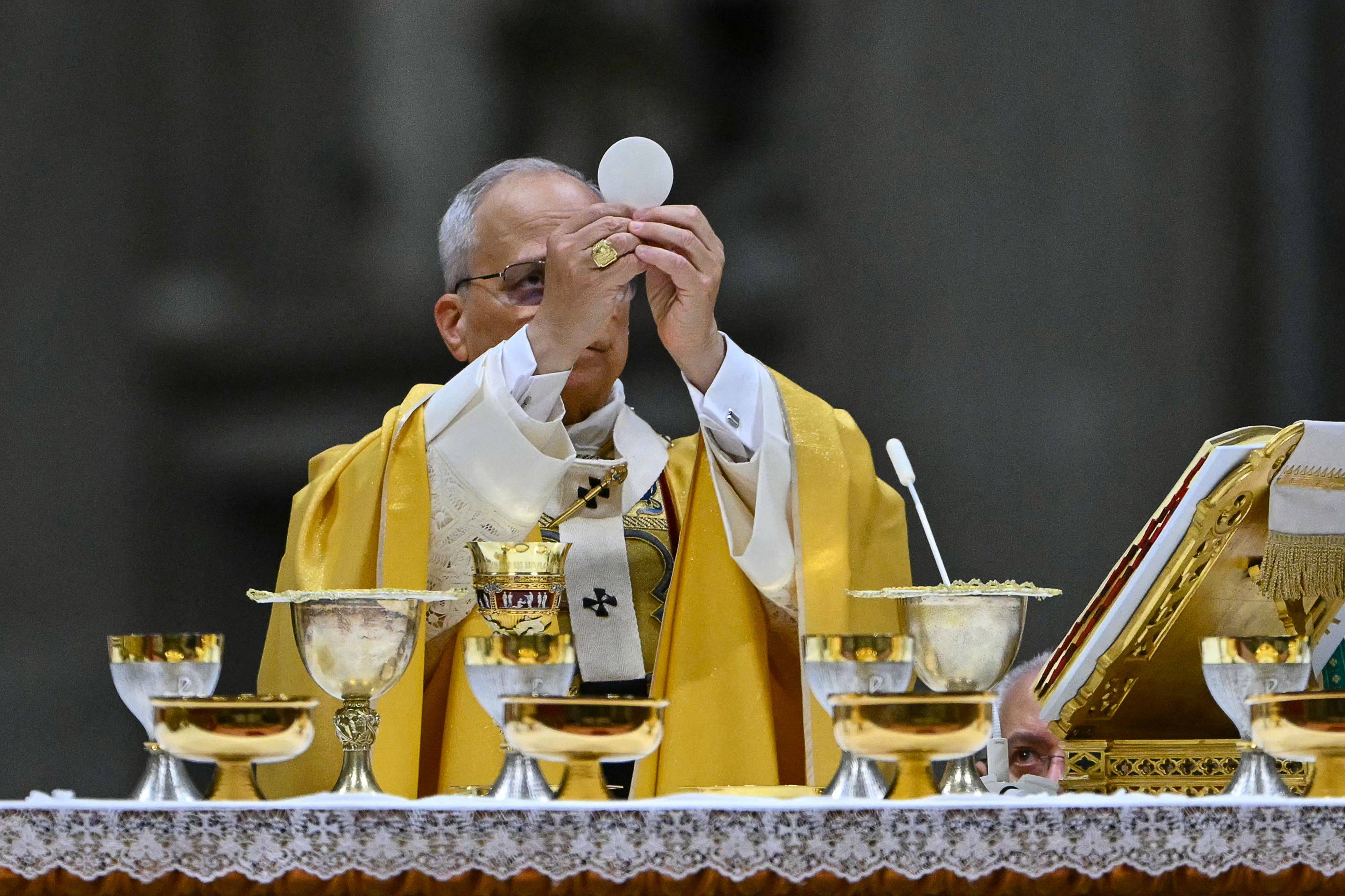 Pope Leo gives communion on Wednesday. Photo: AFP