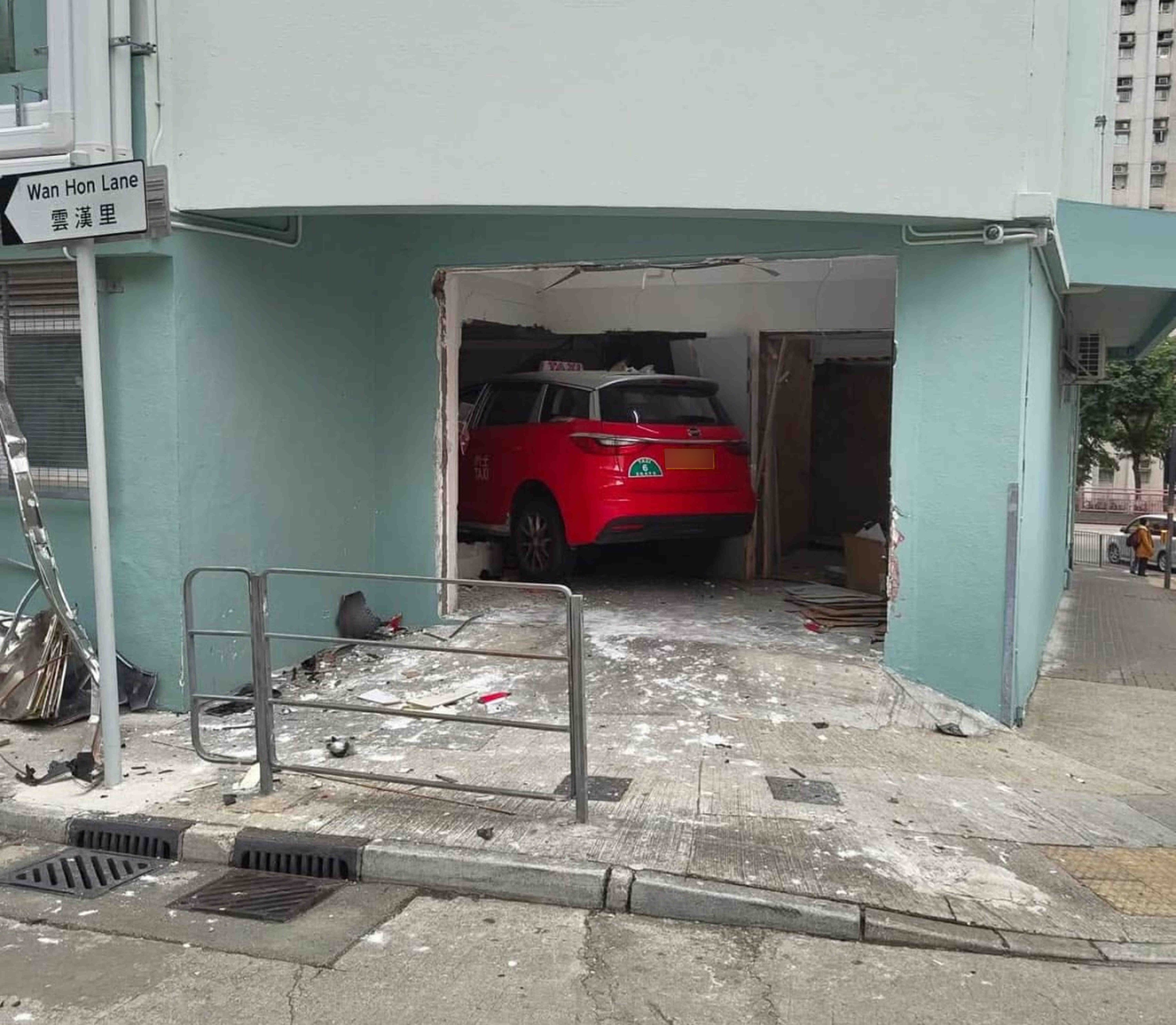 A taxi driver has been hospitalised after her vehicle crashed through the wall of a school building in Kwun Tong. Photo: Handout