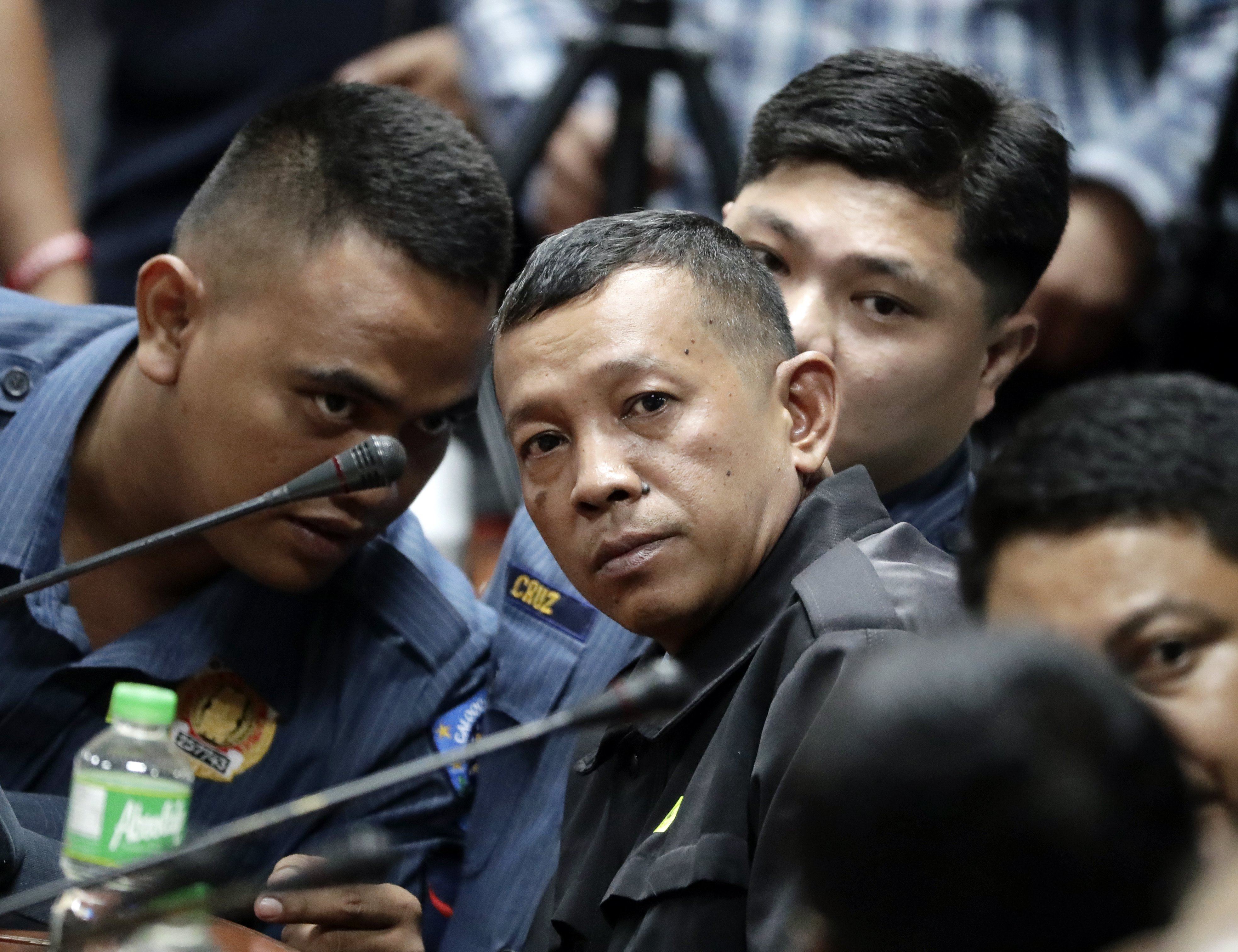 Filipino policemen (from left) Jeremiah Pereda, Arnel Oares, and Jerwin Cruz attend a Senate inquiry in Pasay City on August 24, 2017. Photo: EPA