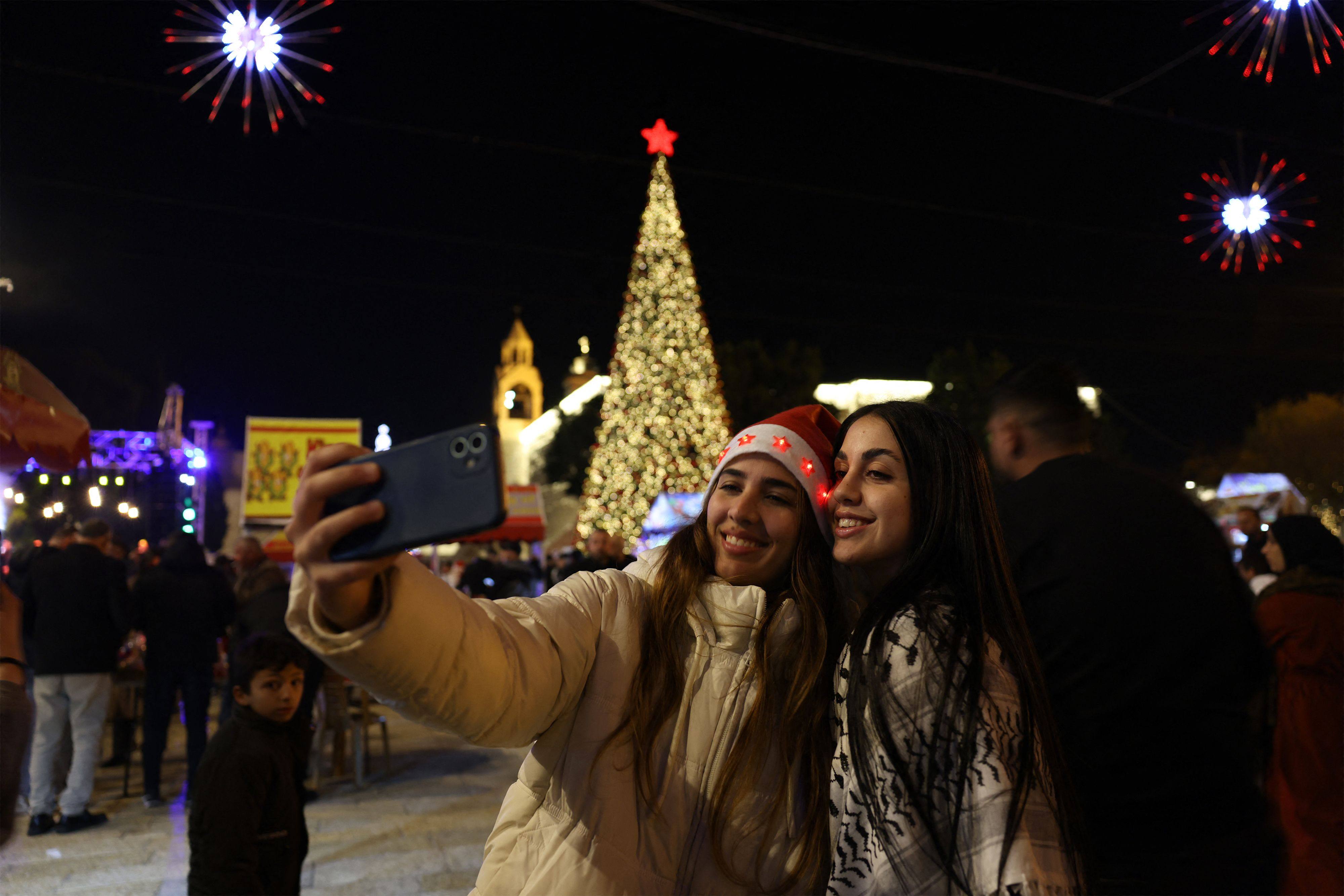 People celebrate in Manger Square in Bethlehem, in the Israeli-occupied West Bank on December 24. Photo: AFP