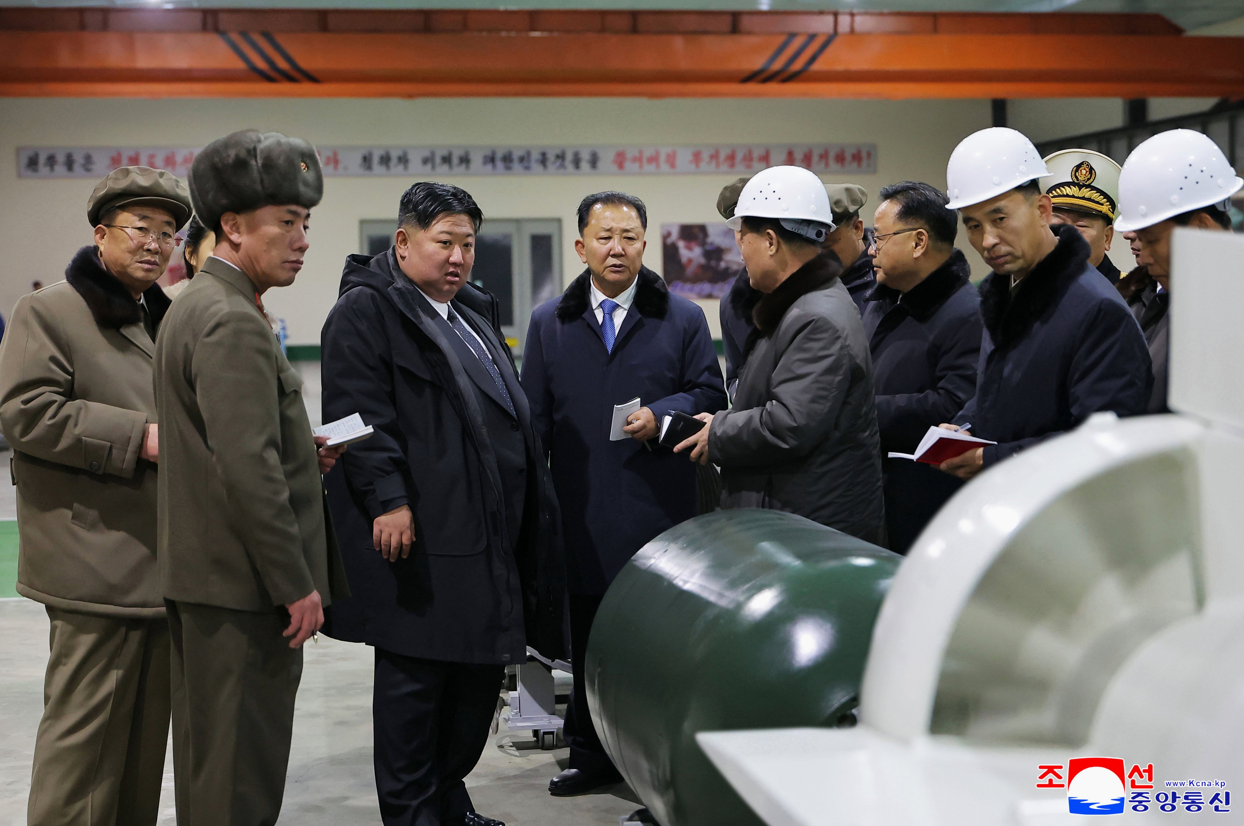 North Korean leader Kim Jong-un (centre)  inspects a nuclear-powered submarine under construction in a photo released on December 25. Photo: KCNA/AP