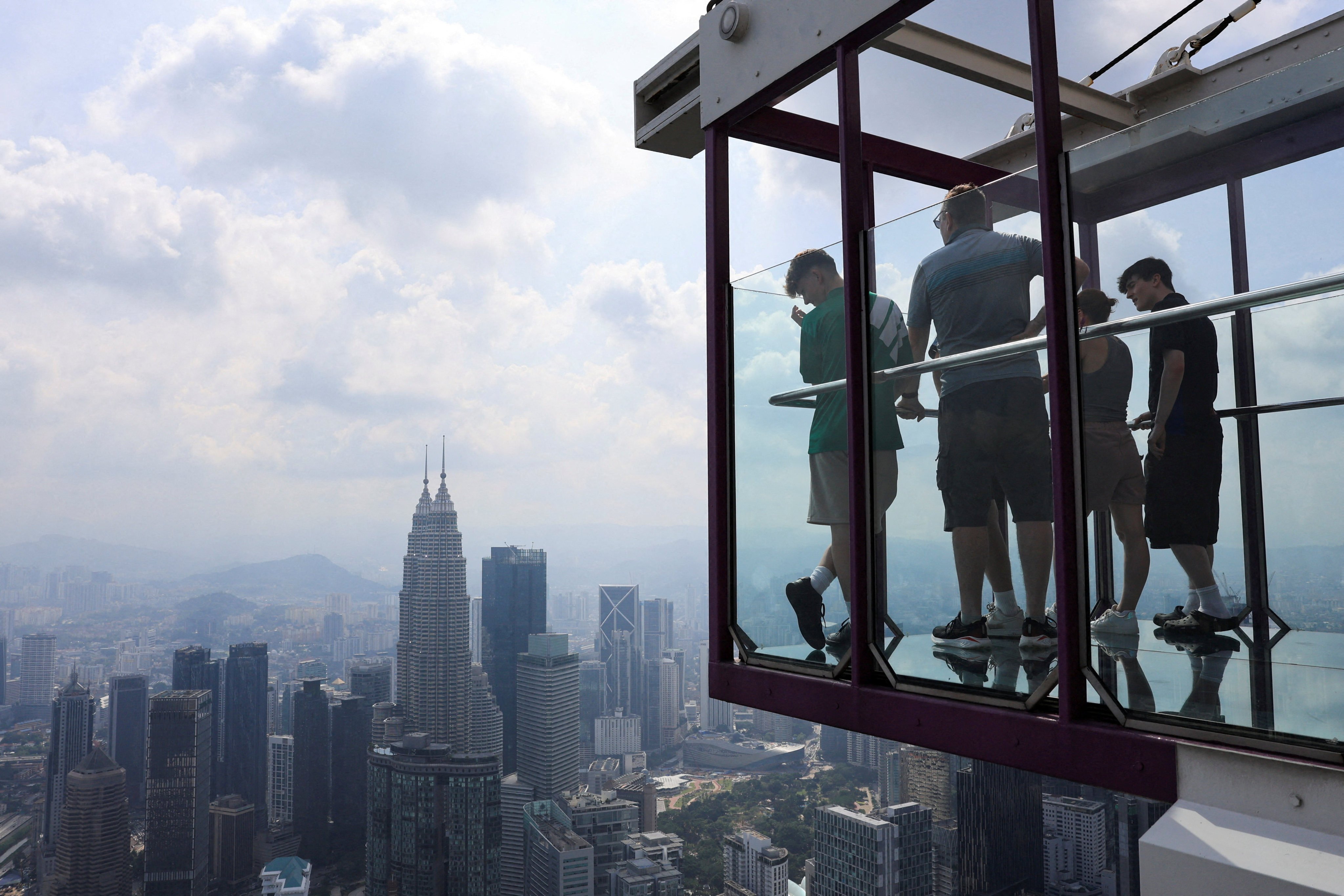 People look at Kuala Lumpur’s skyline from an observation deck in the Malaysian capital. Photo: Reuters