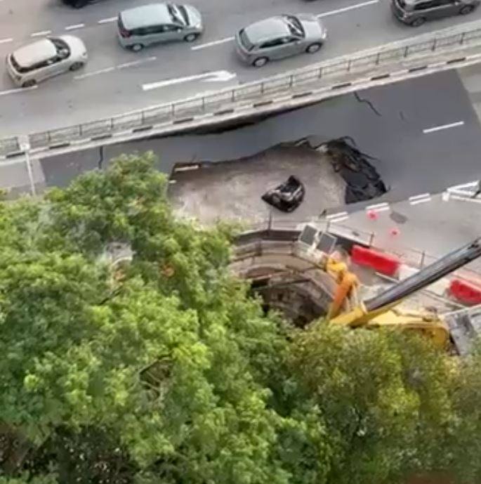 A still from a social media video shows a submerged car after it fell into a sinkhole in Singapore on July 26. Social media users hailed migrant workers for their quick response in saving the driver. Photo: X/HaggerDarren