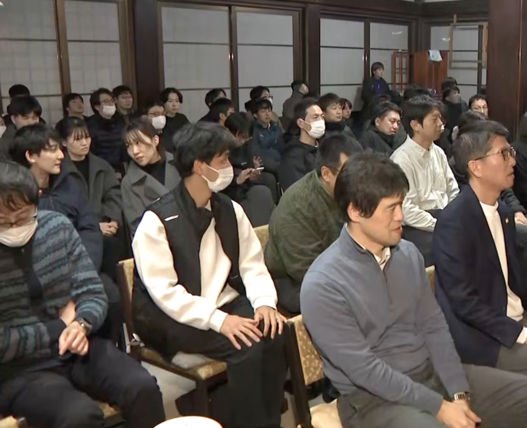 Company employees attend the ceremony. About 100 staff prayed for the dead insects. Photo: ABCTVnews