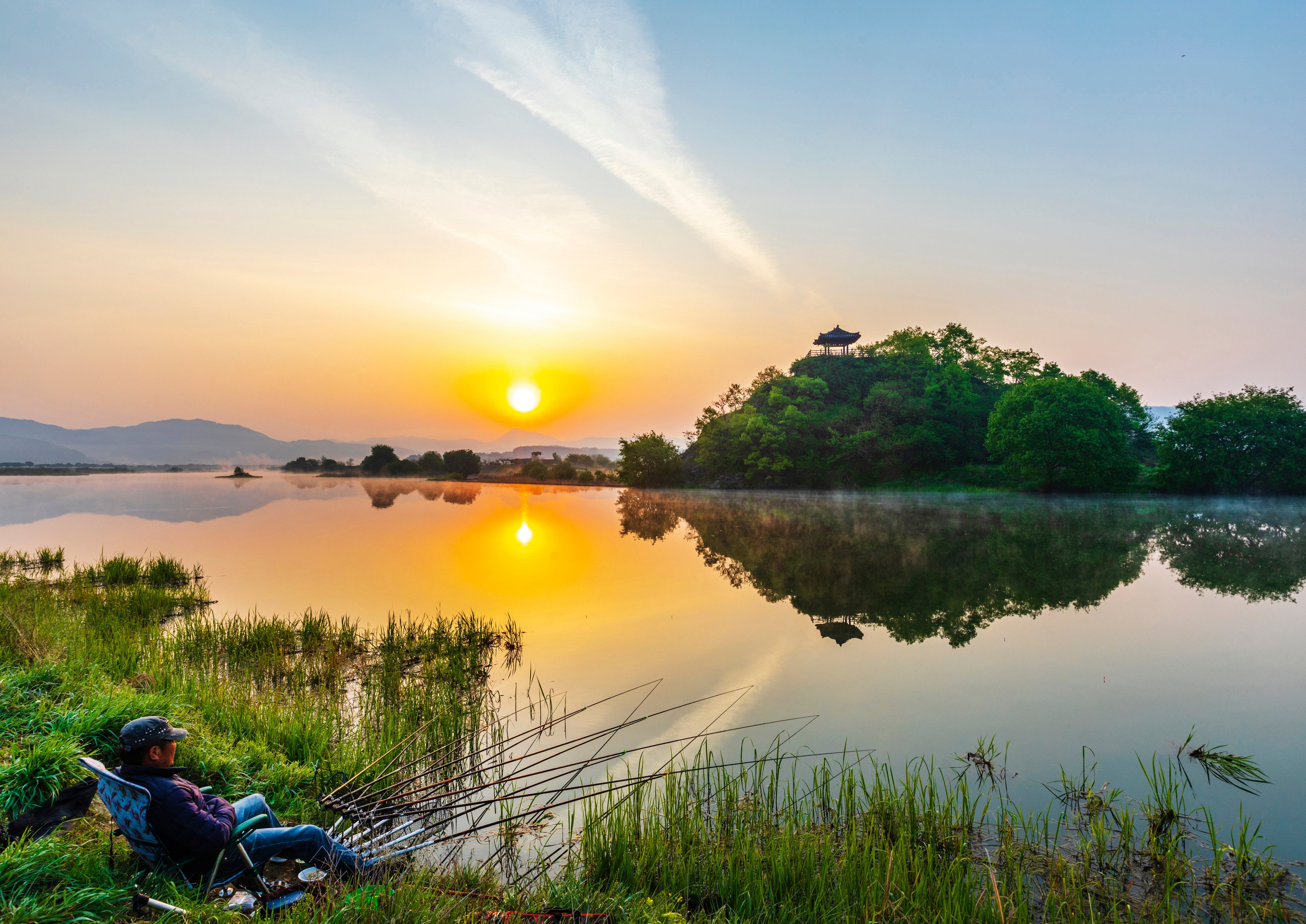 An angler fishing with the background of Sangchunjeong pavilion in Okcheon in North Chungcheong province, South Korea. Photo: Shutterstock