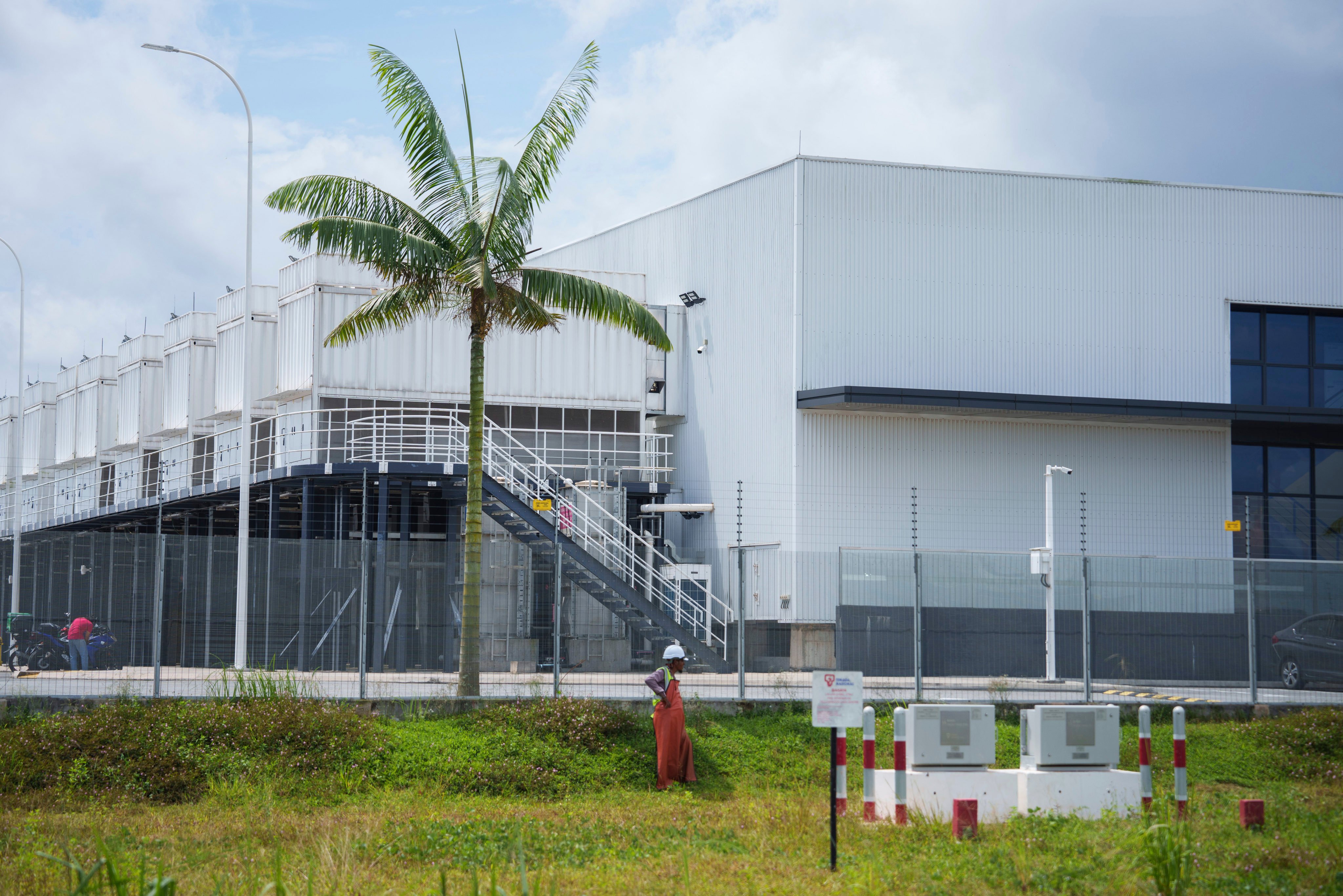 A construction worker stands outside a data centre being built in Sedenak Tech Park in Johor, Malaysia, on September 27, 2024. Emerging AI data centres are giving the region’s main data centre hubs, Japan and Singapore, a run for their money. Photo: AP