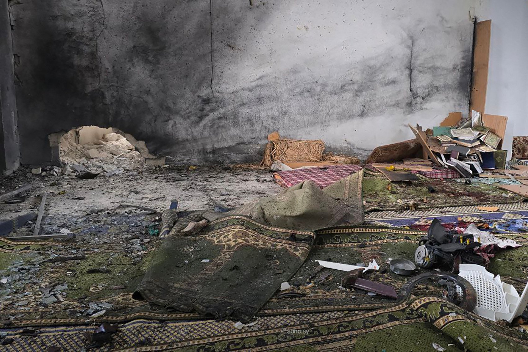 The aftermath of the explosion inside Imam Ali ibn Abi Talib Mosque in the Wadi al-Dahab neighborhood of Homs. Photo: SANA/AFP