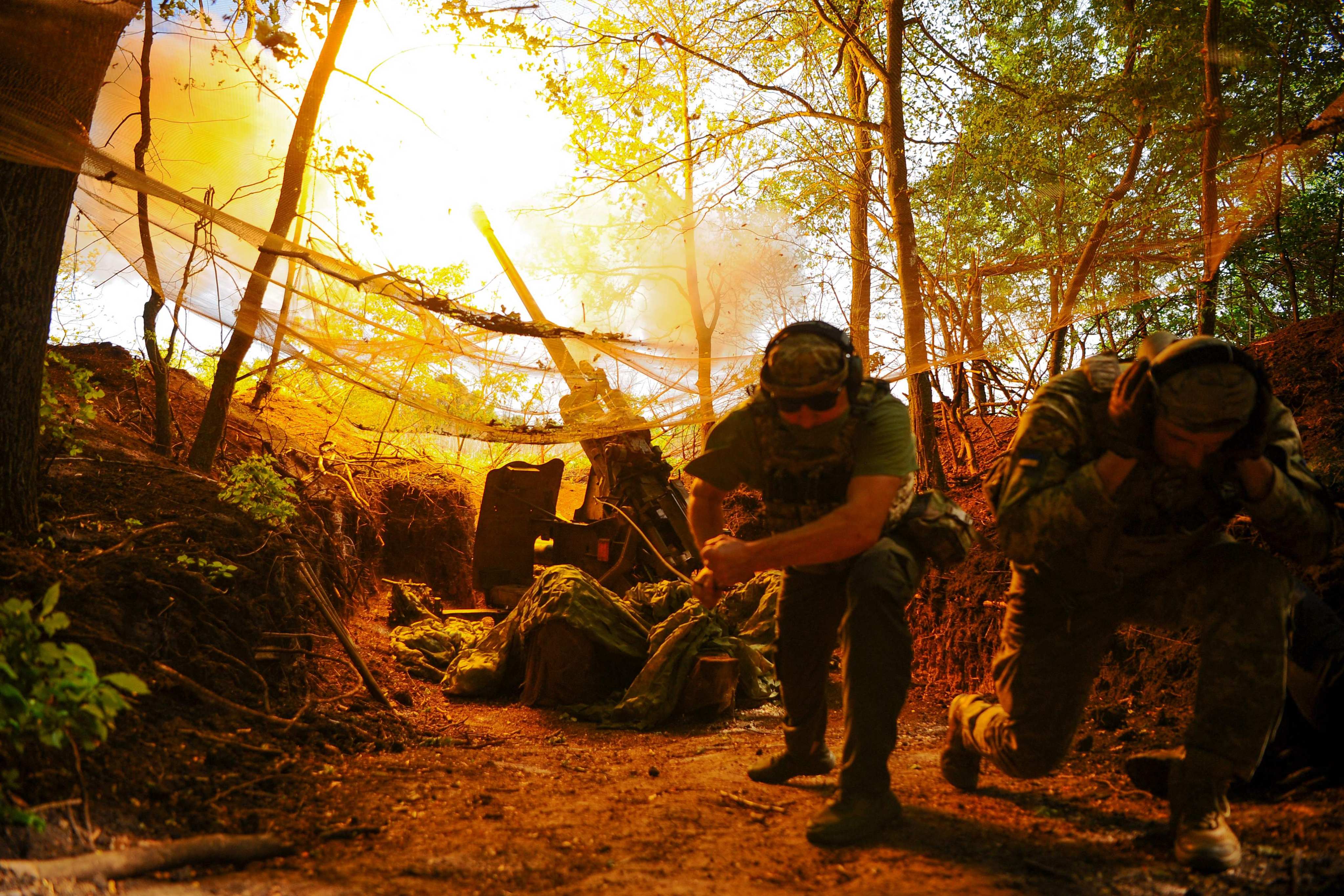 Members of the Ukrainian military take cover during an operation in June. Photo: AFP