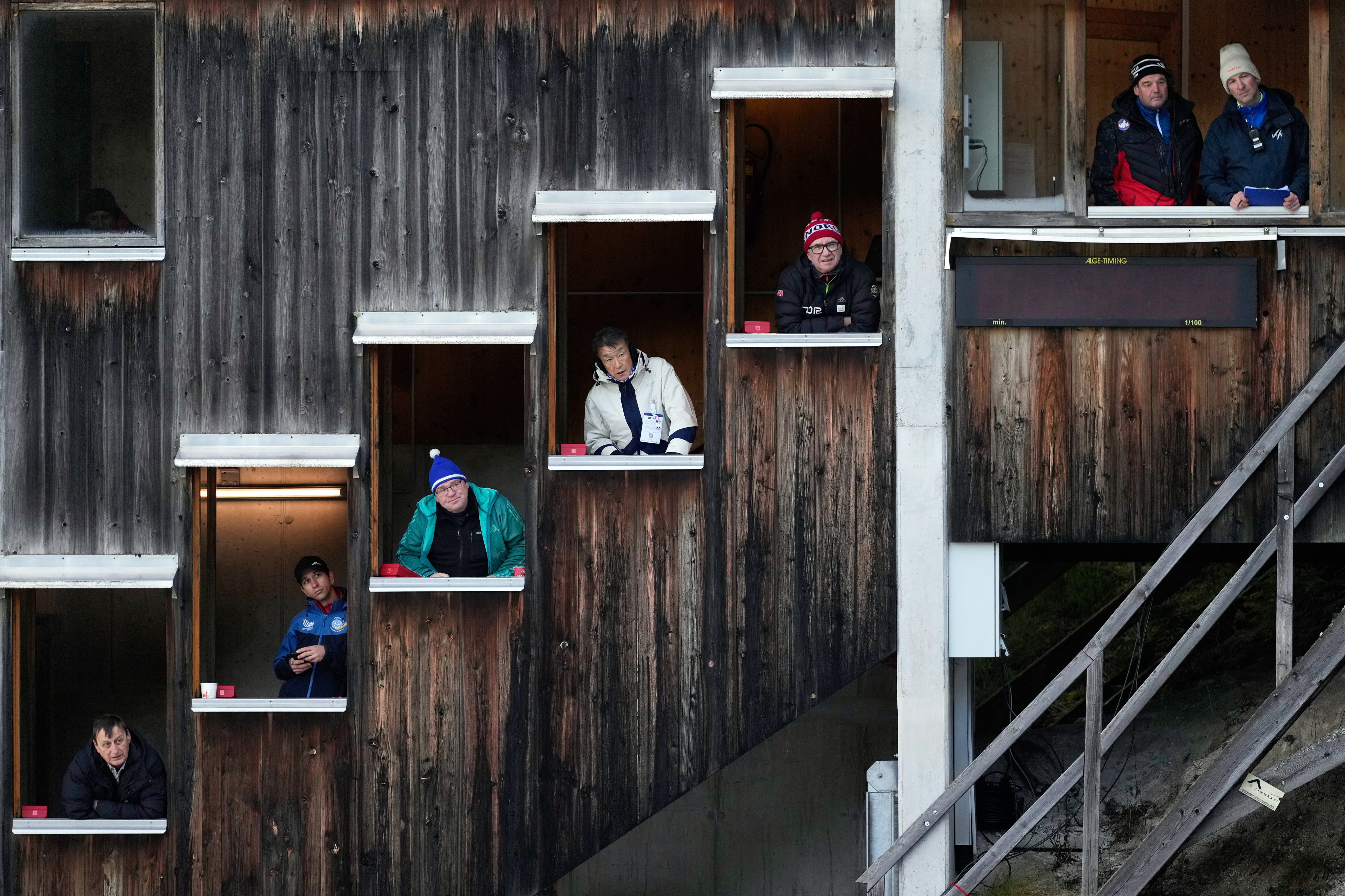 Judges watch from their windows during the men’s Individual Gundersen Normal Hill/10Km event, at the Nordic Combined World Cup in Ramsau am Dachstein, Austria. Photo: AP