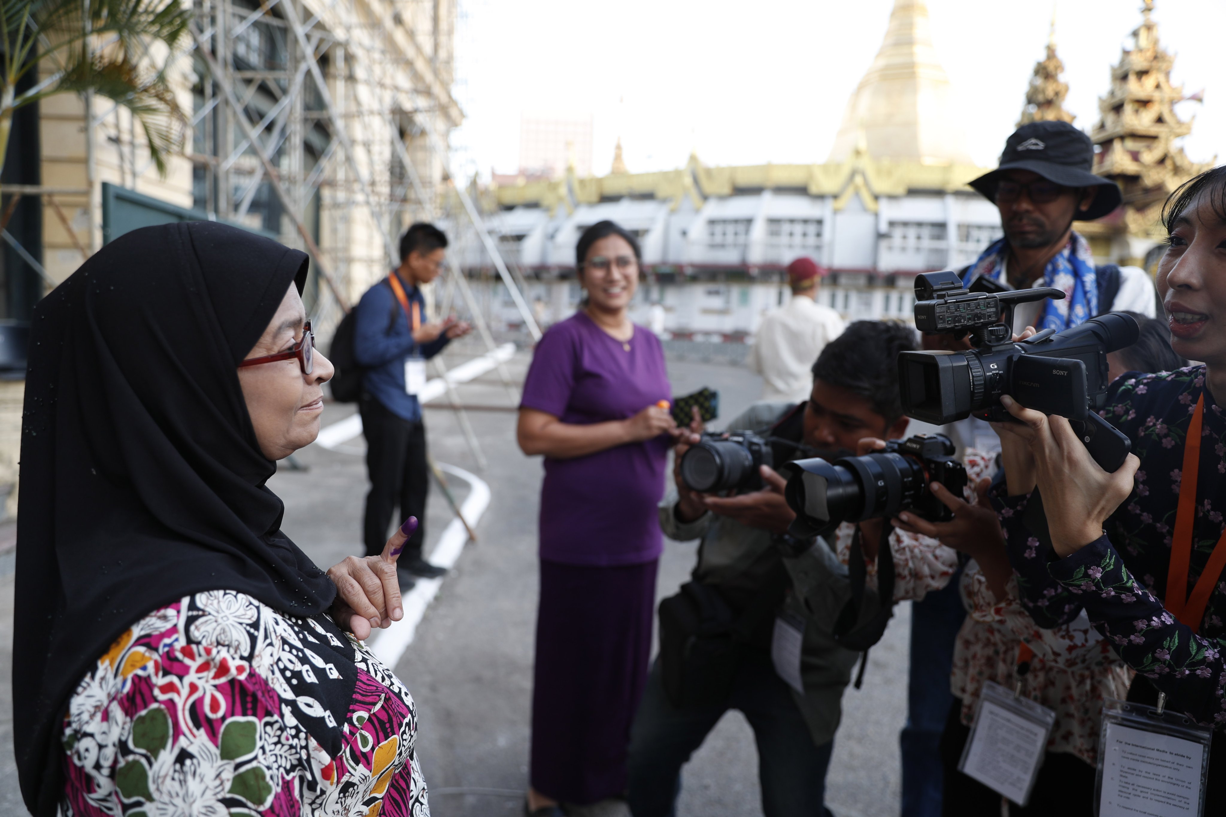 A voter shows her inked finger after casting a ballot in Yangon, Myanmar, on Sunday. Photo: EPA