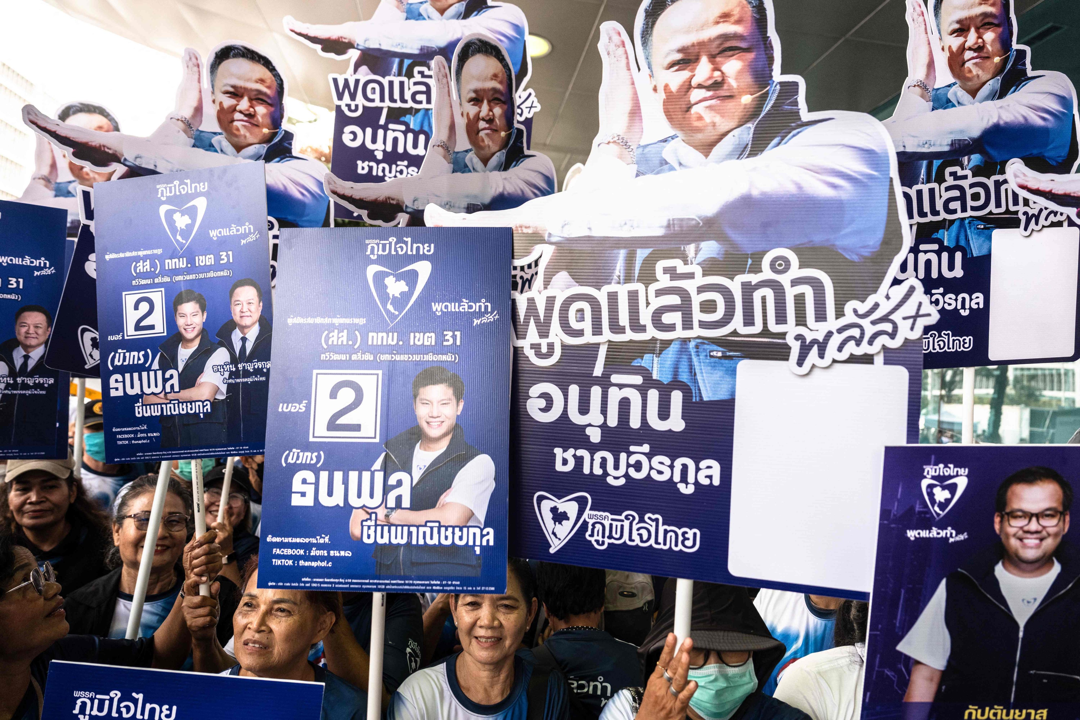 Supporters with placards back Thai PM Anutin Charnvirakul on the first day of candidate registration in Bangkok on Sunday. Photo: AFP