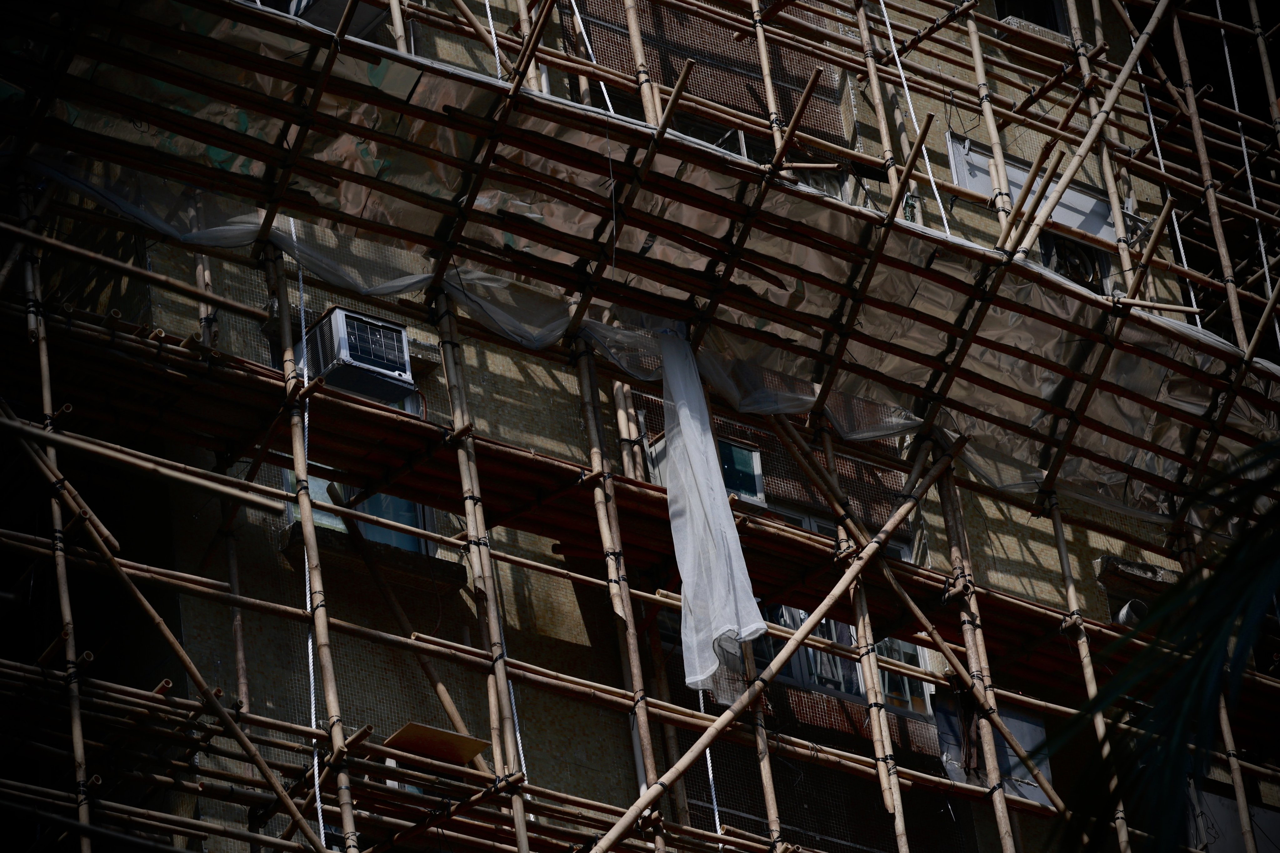 Bamboo scaffolding encases a building under repair in Hong Kong’s Sham Shui Po district on December 5. Hong Kong’s stock of ageing buildings presents a structural challenge. Photo: EPA