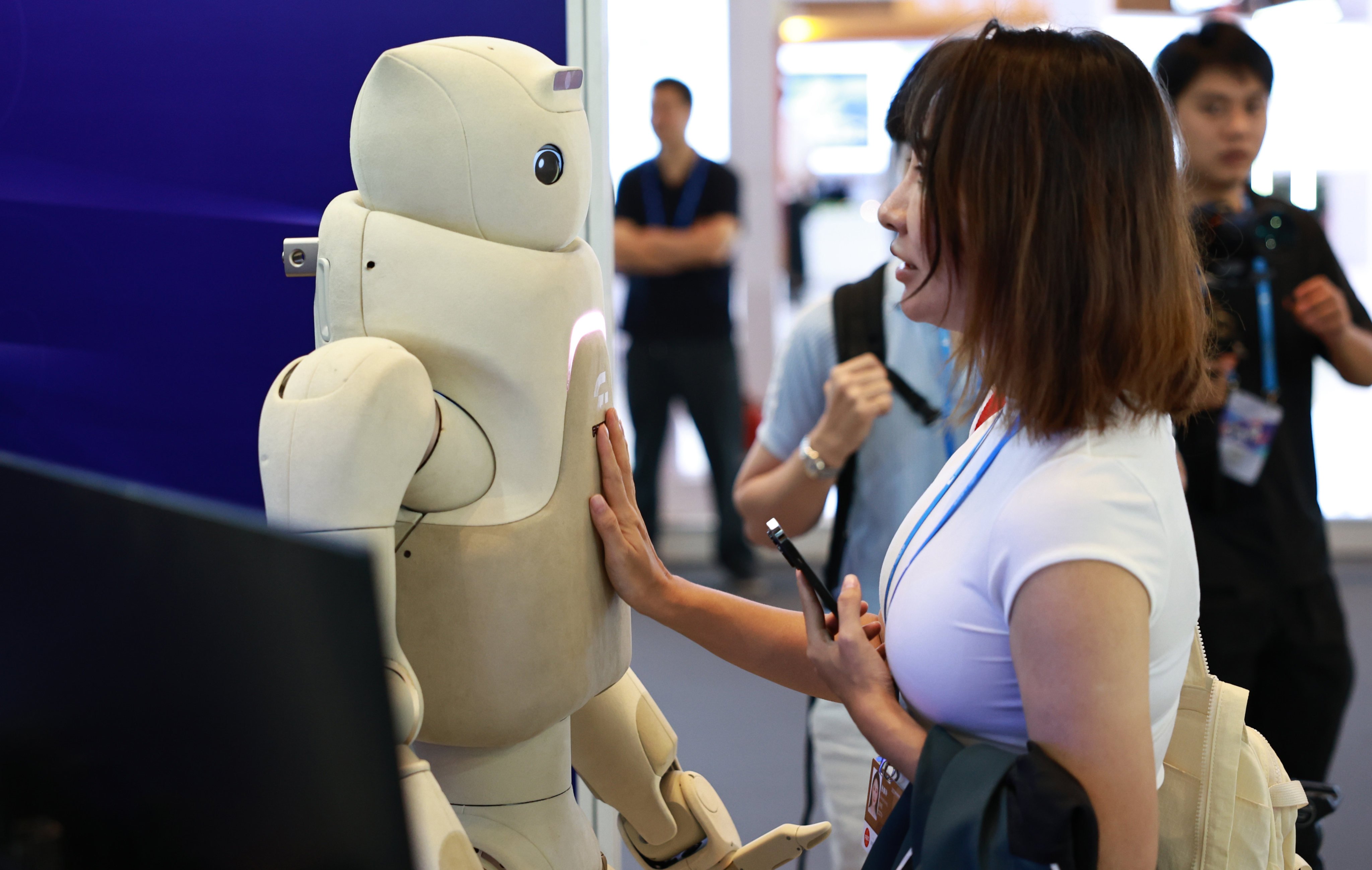 A visitor interacts with a robot at the Pujiang Innovation Forum in  Shanghai on September 21. Photo: Xinhua