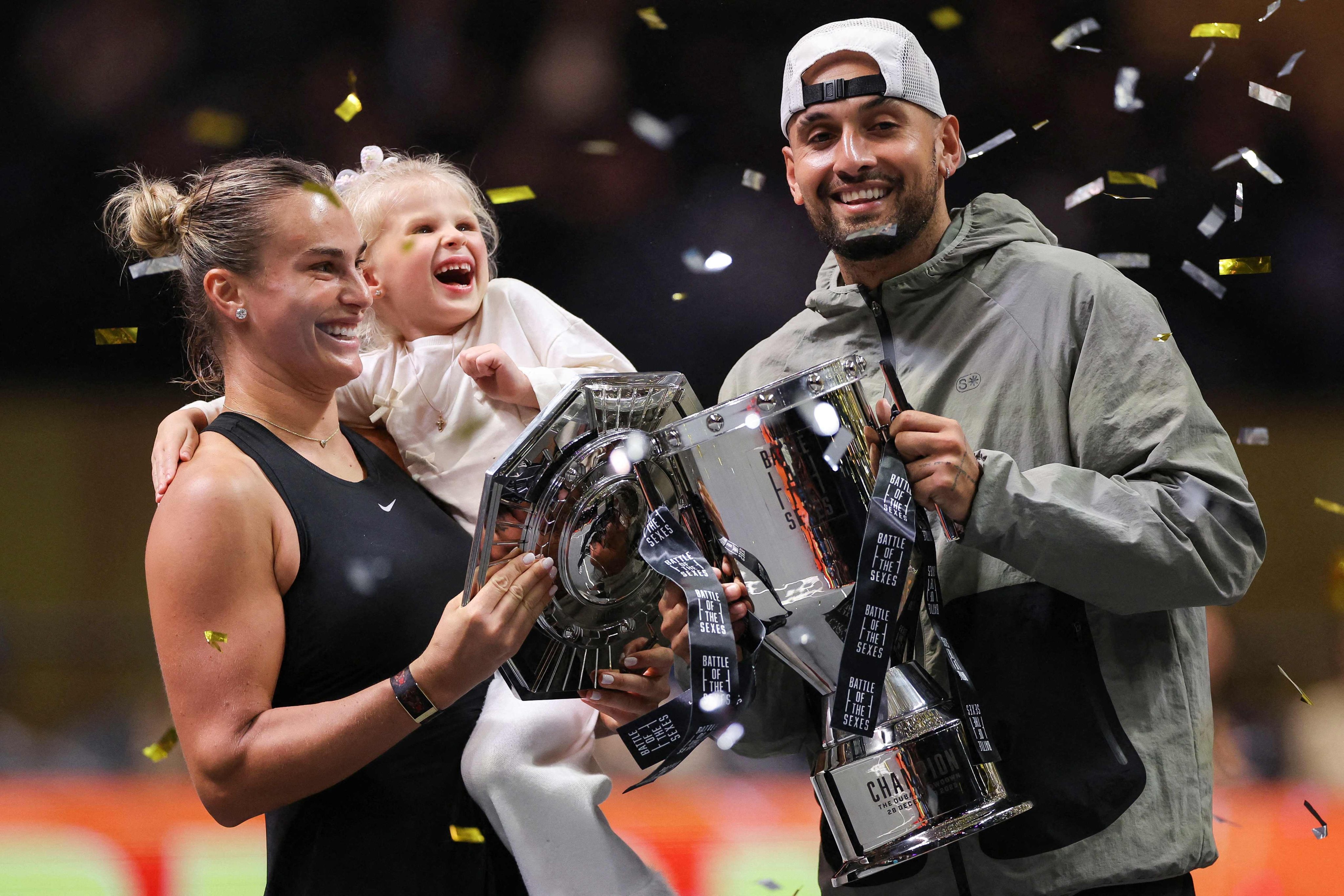 Aryna Sabalenka (left), her goddaughter Nicole, and Nick Kyrgios celebrate at a packed Coca-Cola Arena in Dubai. Photo: AFP