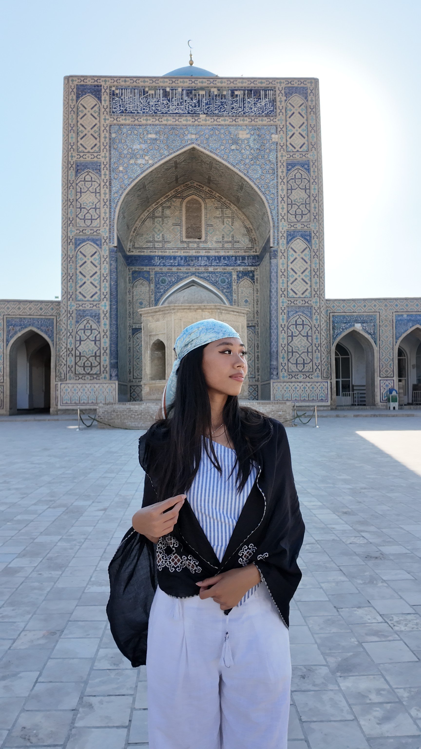 Kaylie Lau outside Kalan Mosque, in Bukhara, Uzbekistan. Earlier this year, the Post spoke to the Hongkonger who is currently on a trip from Asia to Europe, taking no flights and carrying only one backpack. Photo: Kaylie Lau