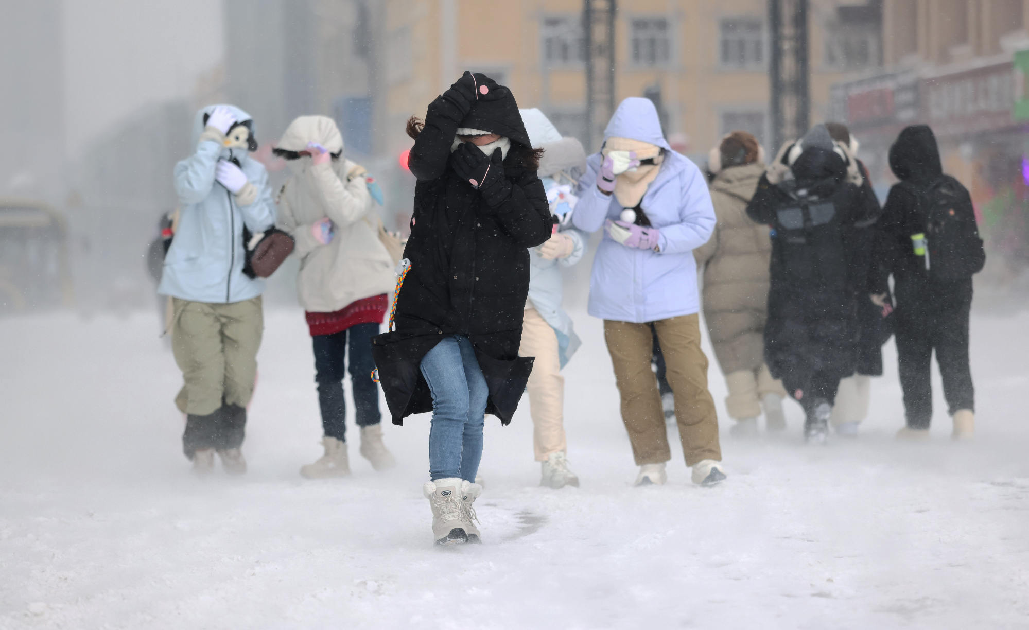A number of people travelled through traffic jams caused by the snowy weather in Harbin, above. Photo: Xinhua A number of people travelled through traffic jams caused by the snowy weather in Harbin, above. Photo: Xinhua