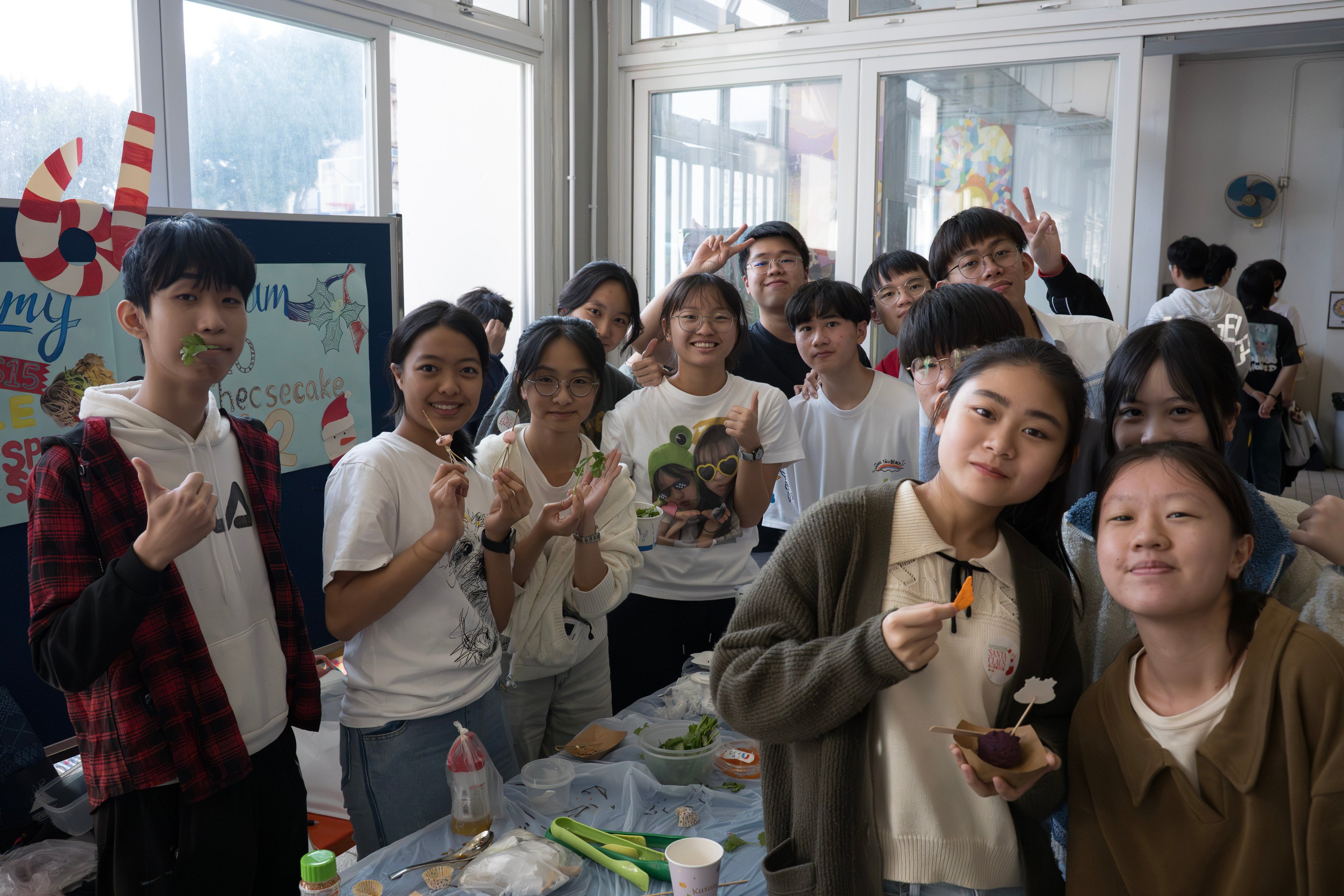 Students pose at a stall during a charity food fair at Shung Tak Catholic English College. Photo: Handout