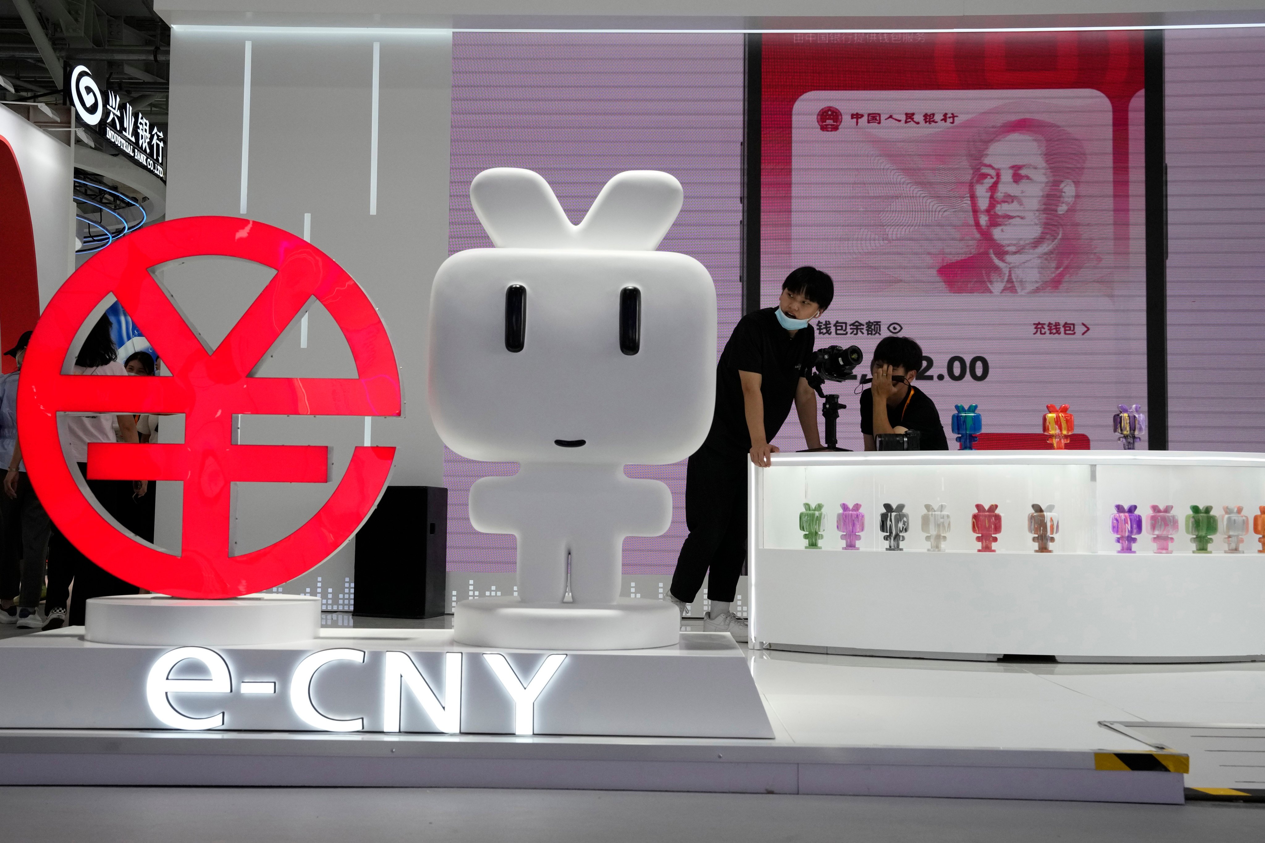 A booth promotes the digital yuan at an expo in Beijing. China is upgrading its digital currency as it aims to create an alternative to stablecoins and cryptocurrencies. Photo: AP