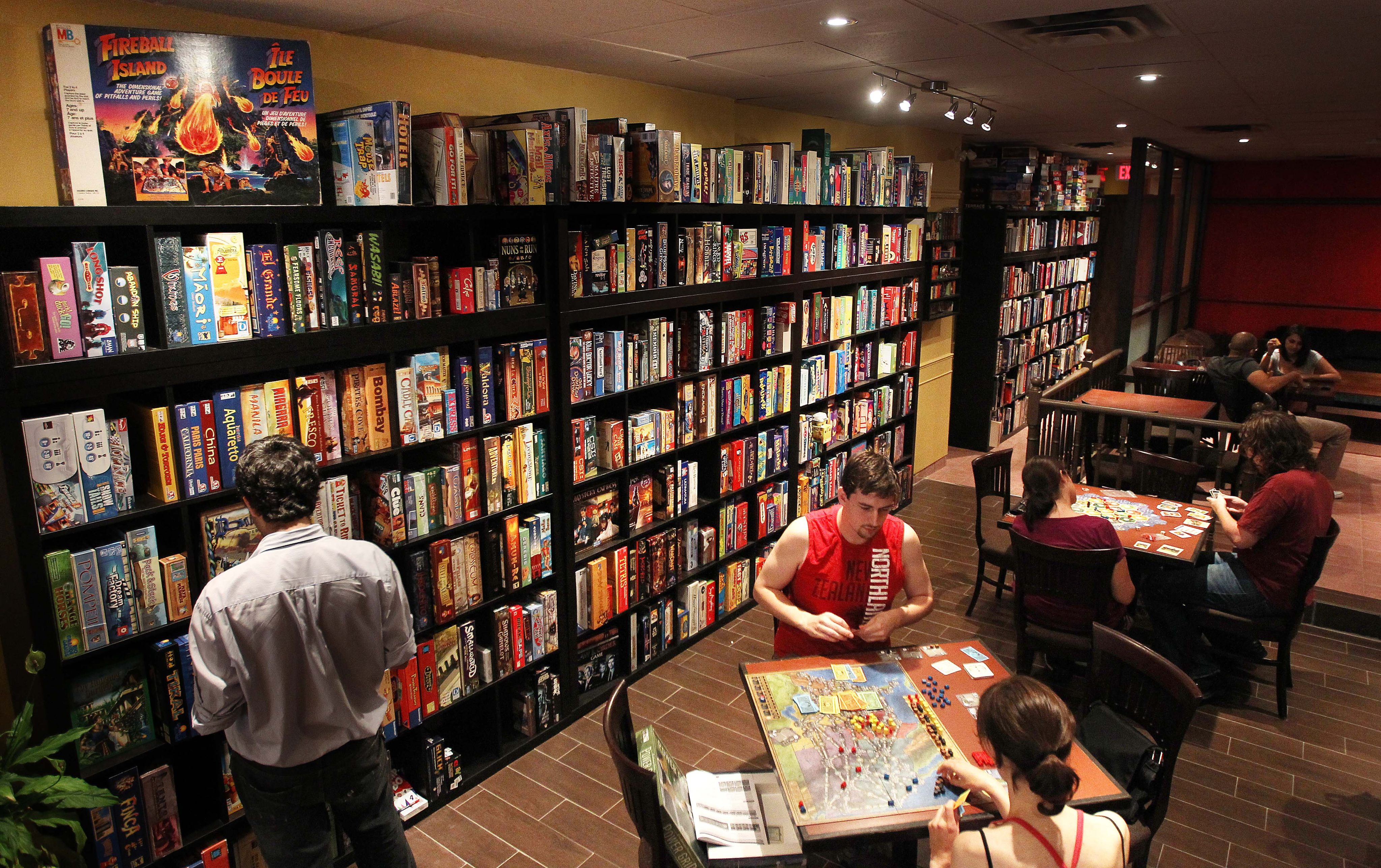Snakes and Lattes, a board game cafe in Toronto, has many games on site. Play games in places like this to connect with locals when you are on your travels. Photo: Toronto Star via Getty Images