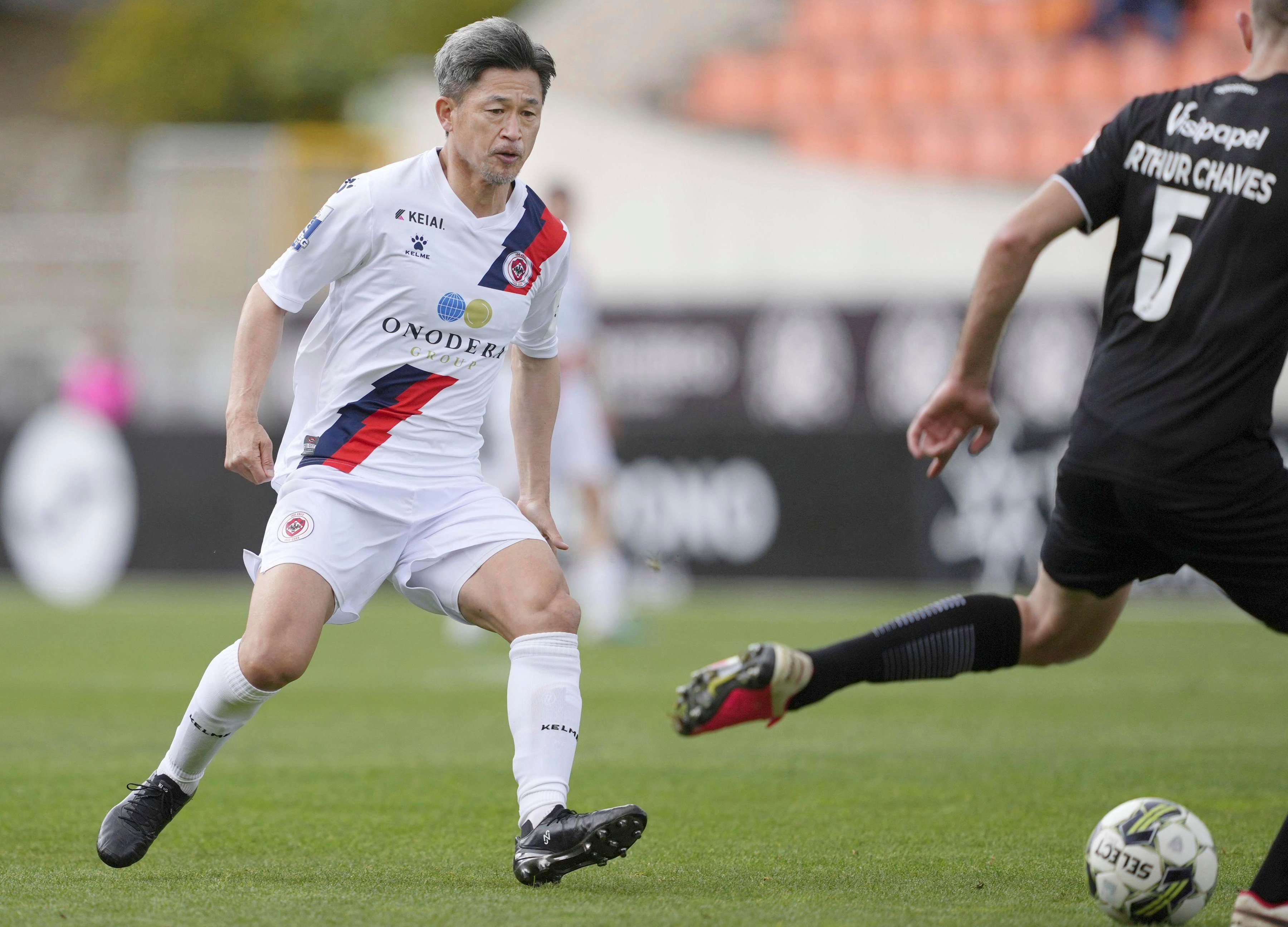 Kazuyoshi Miura (left) playing for U.D Oliveirense against Academico de Viseu FC in Portugal when he was 56 years old. Photo: AP