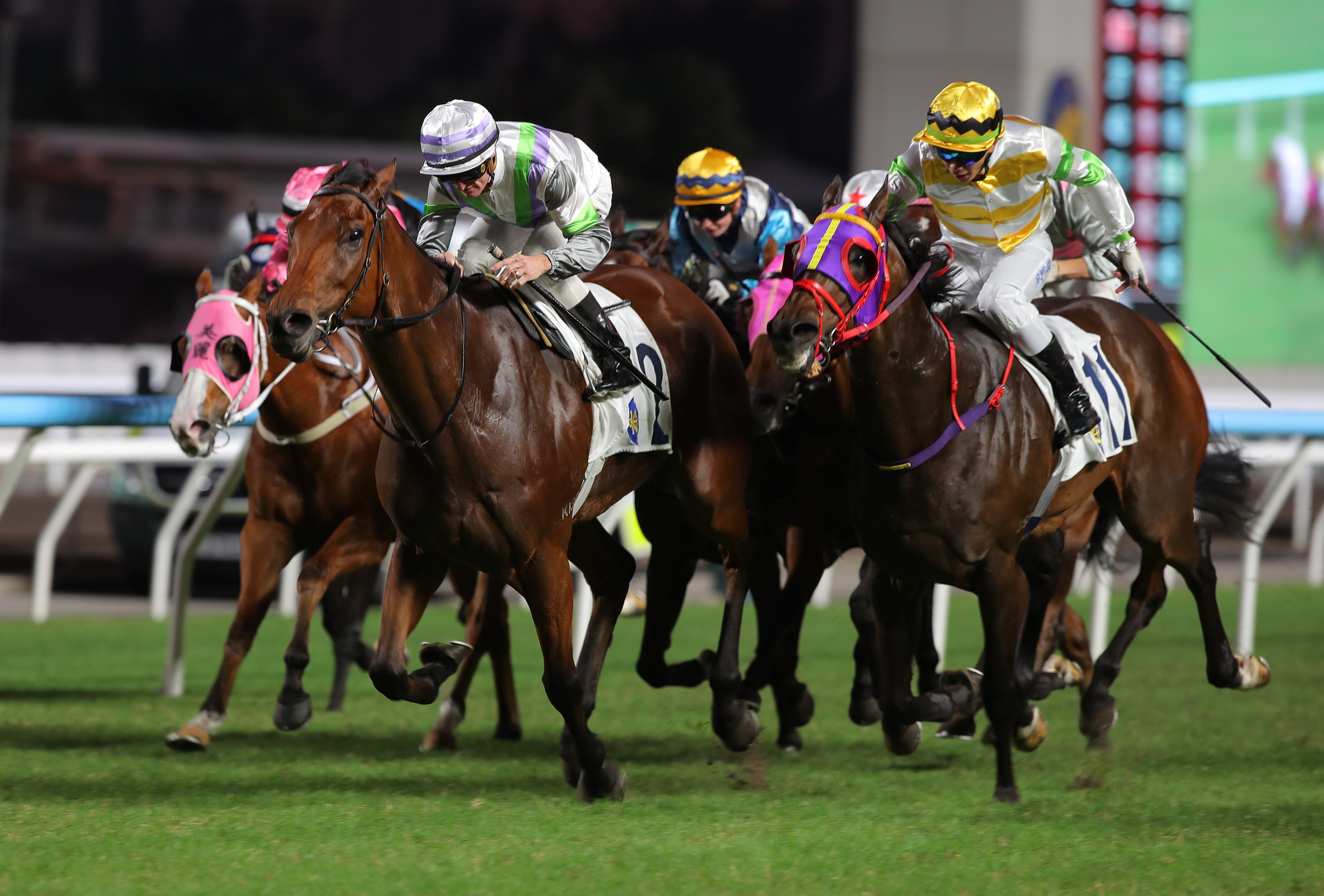 Light Years Charm (white, purple and green) gets up to beat Aeris Nova at Sha Tin. Photos: Kenneth Chan