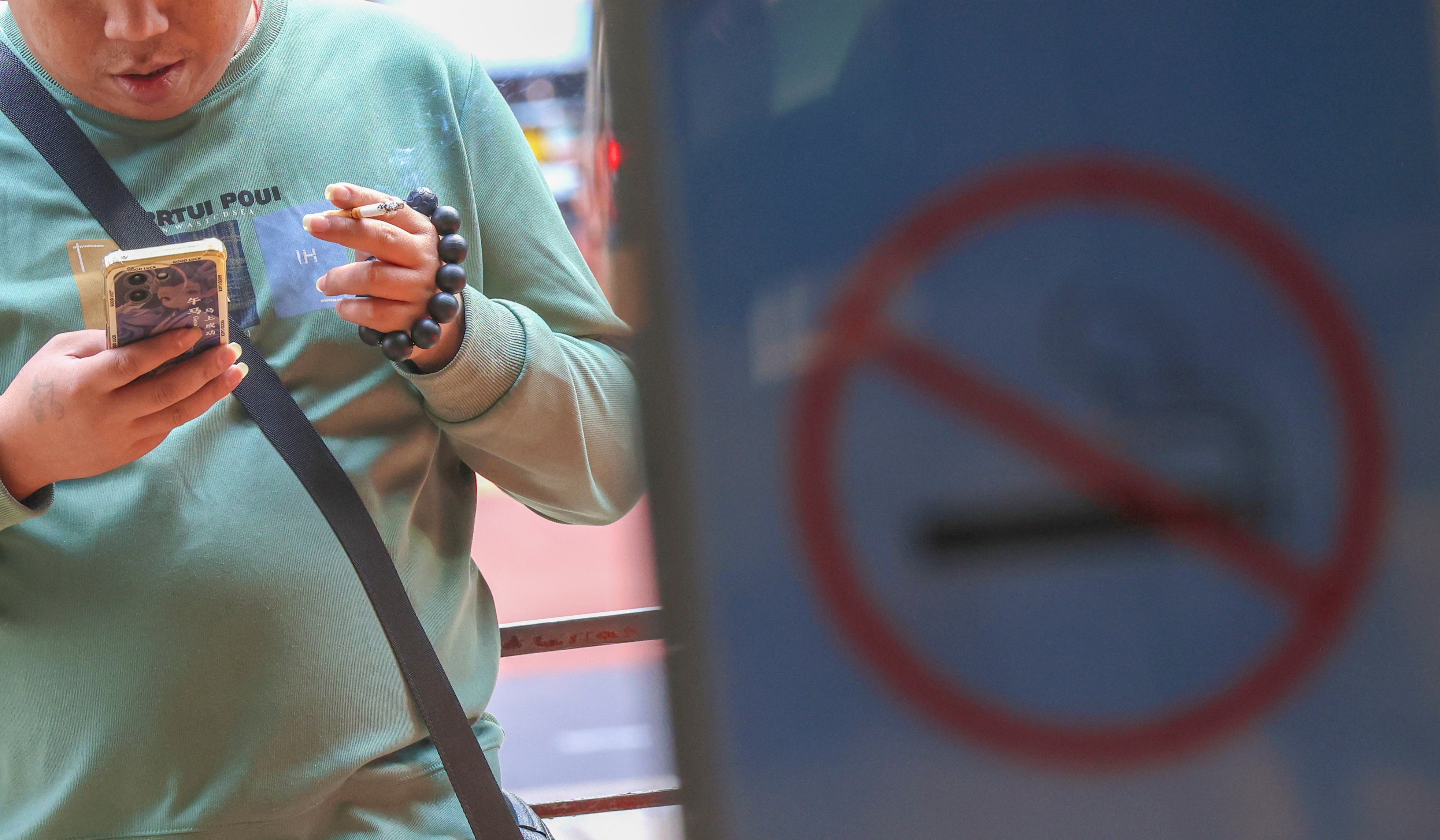 A resident smokes along Canton Road in Tsim Sha Tsui. Photo: Jelly Tse