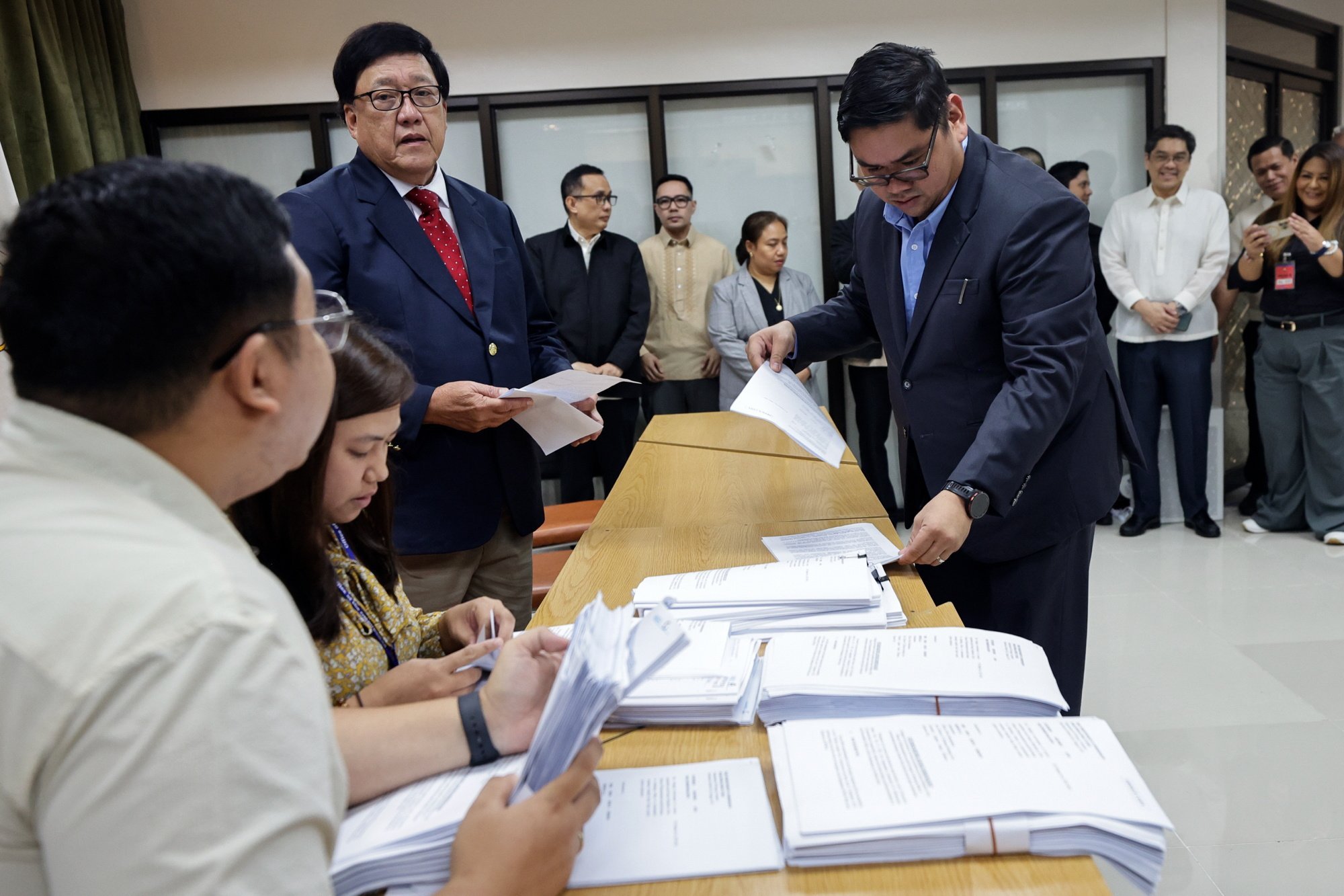 Independent Commission for Infrastructure chair Andres Reyes Jr (left) oversees the submission of investigation reports to the Office of the Ombudsman in Quezon City, Metro Manila, on October 29 as the panel probes alleged corruption in flood-control infrastructure projects. Photo: EPA