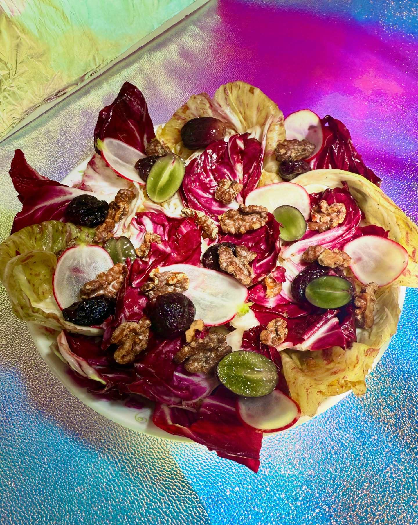 Popular dishes from Lion Dance Cafe in Oakland, California, such as pink salad with radicchio, black vinegar, walnuts and grapes, in the new cookbook. Photo: Instagram/liondancecafe