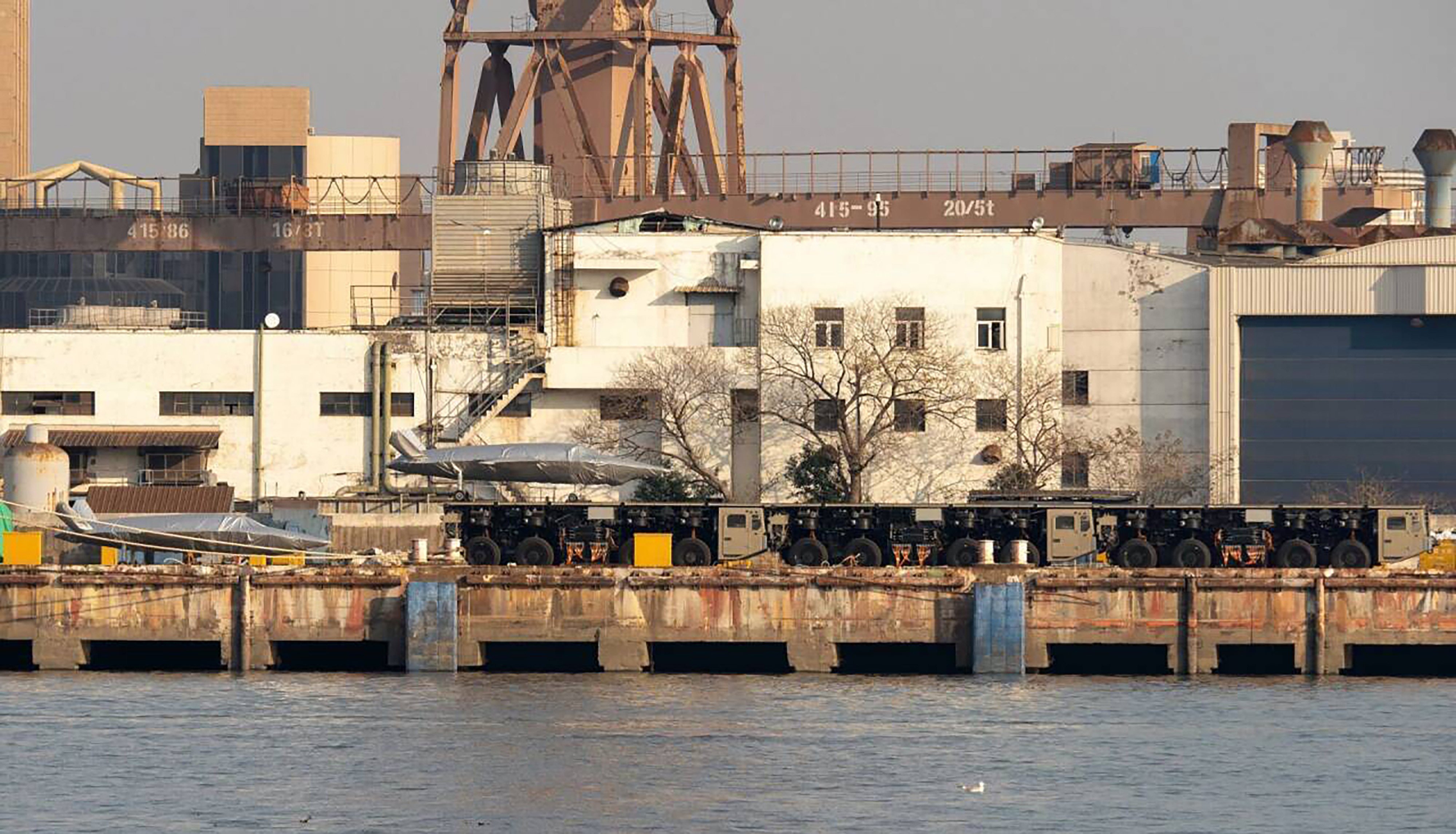 Three trucks linked to form what appears to be a launch track for large drones have been spotted at a dock in China. Photo: Handout