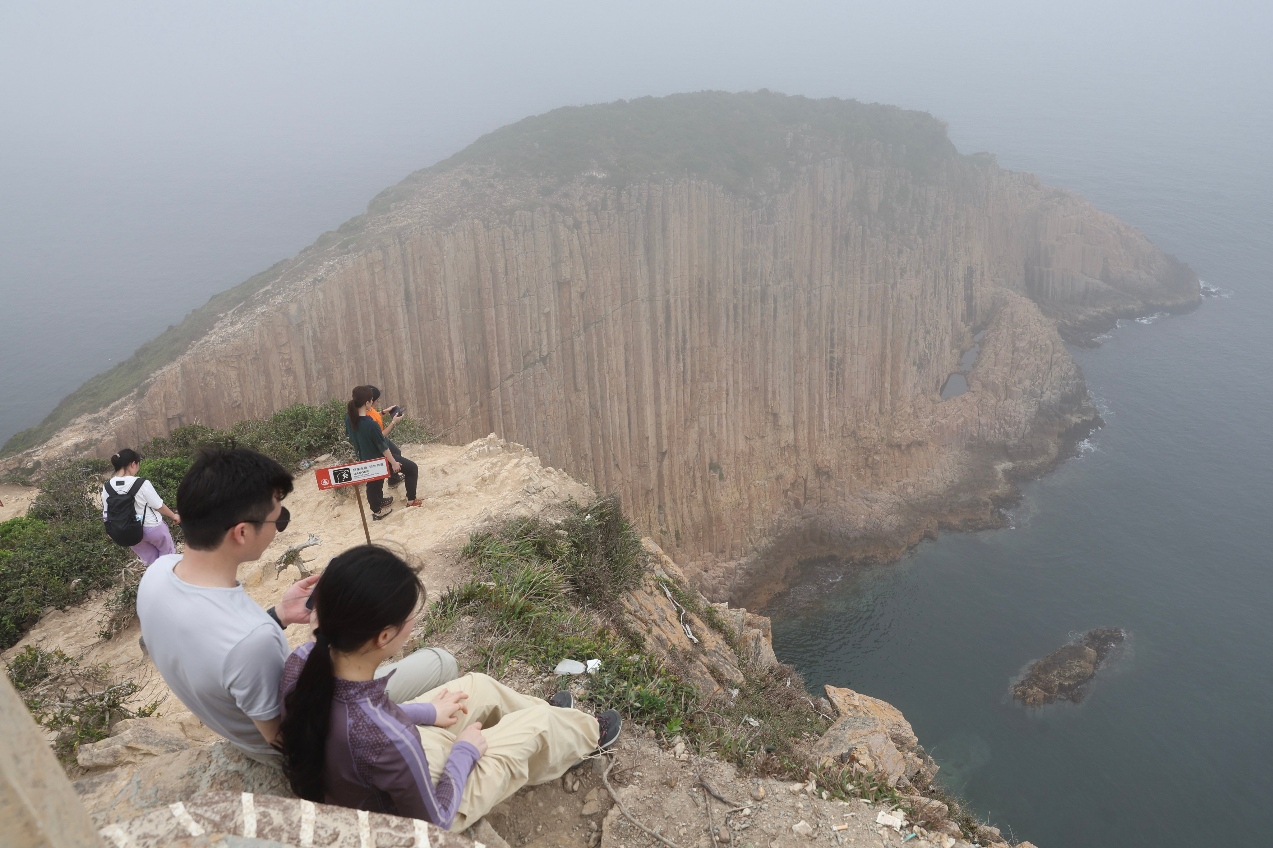 Daring tourists check out the scenery at the Po Pin Chau viewing platform. Photo: Edmond So