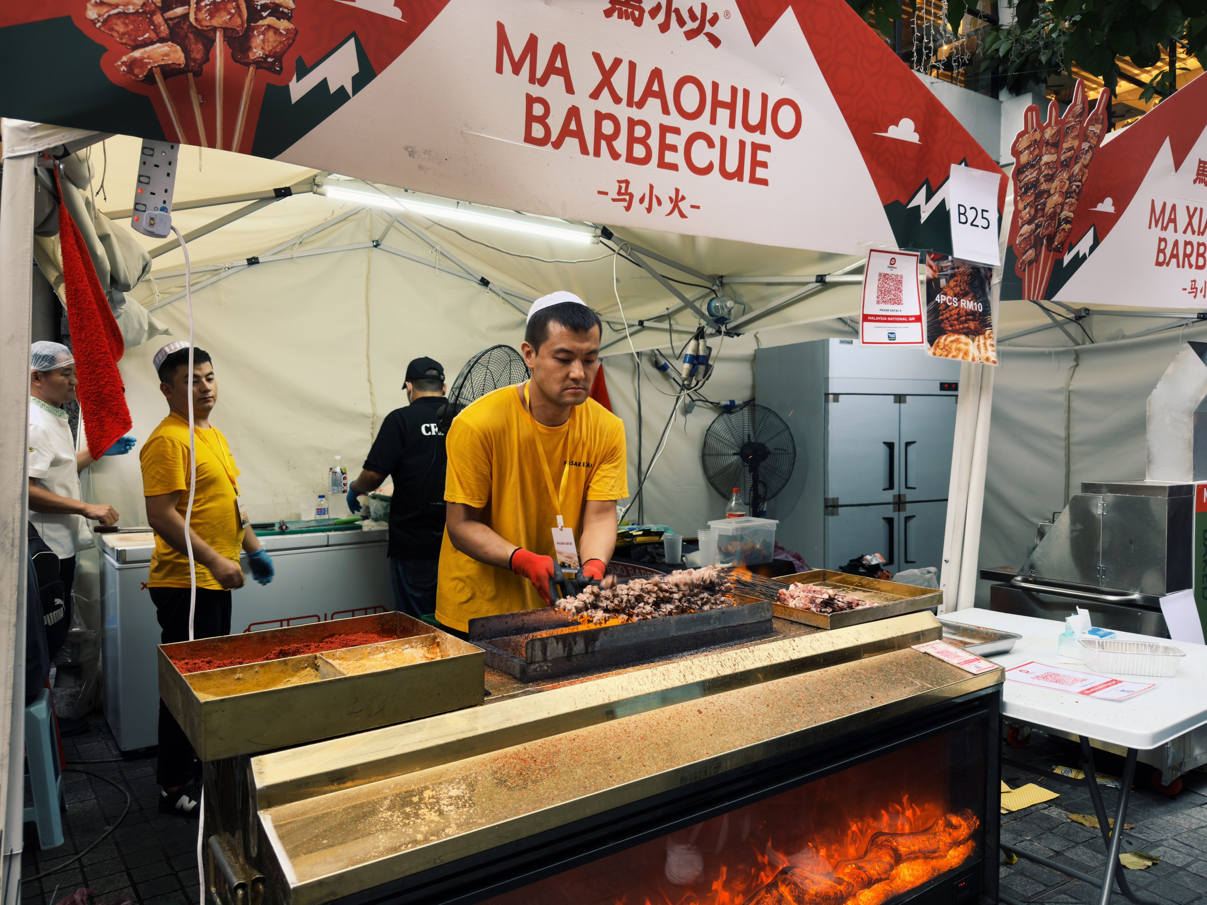 A vendor grills skewered meats at the Pasar Eatai Chinese Muslim Festival at 1 Utama Shopping Centre in Kuala Lumpur on Tuesday. Photo: Iman Muttaqin Yusof