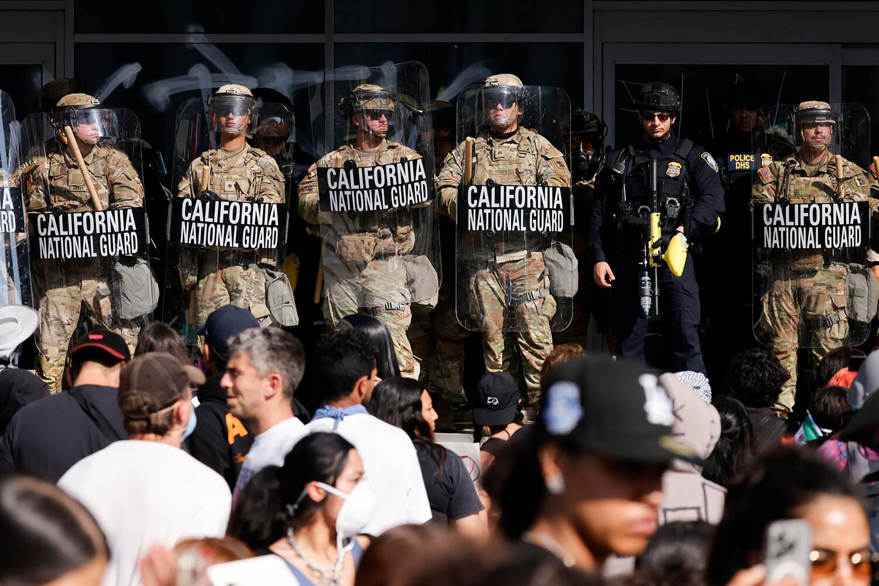 California National Guard members hold a line in front of anti-ICE protesters in Los Angeles in June. Photo: TNS