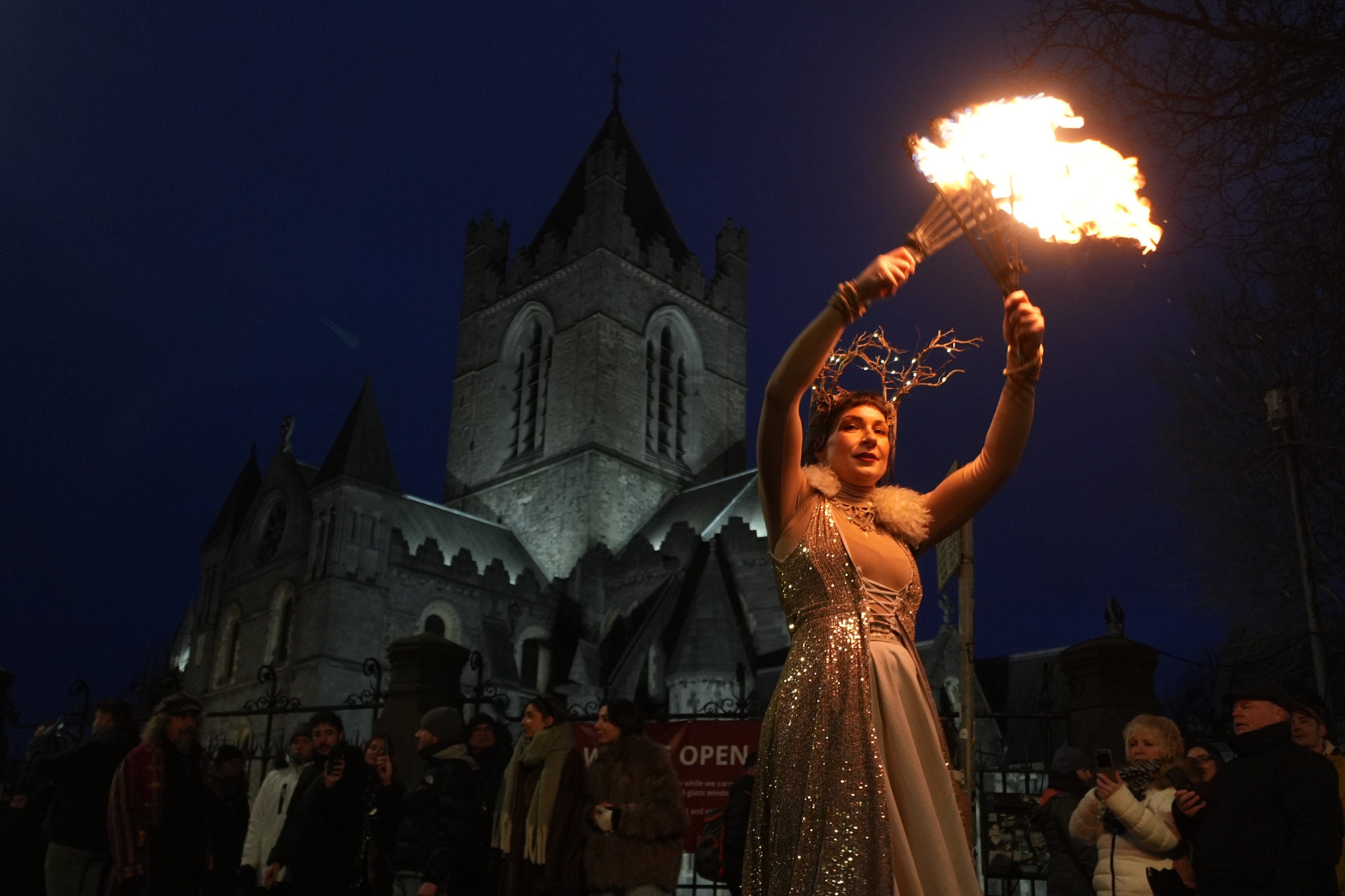 A street performer takes part in the Procession of Light as it passes the Christ Church Cathedral en route to Dublin Castle in Ireland on Wednesday. Photo: PA Wire via dpa