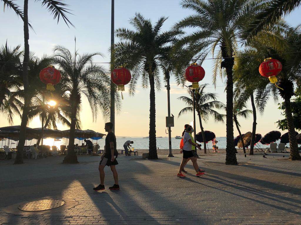 Red lanterns hang along South Pattaya beach as tourists walk past ahead of Chinese New Year. Photo: Vijitra Duangdee