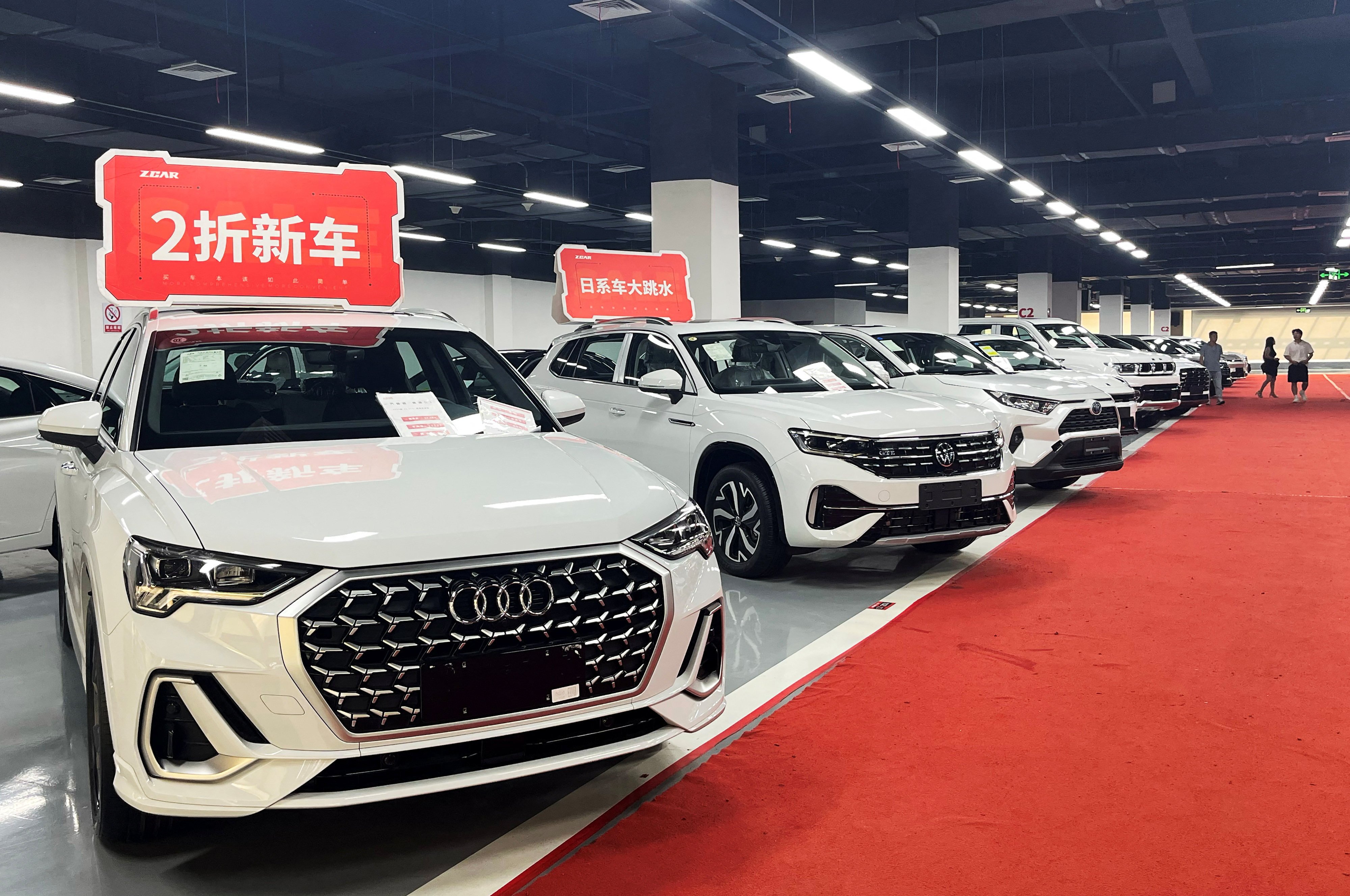 New cars are advertised for sale at deep discounts at a showroom in Chengdu, southwest China. Photo: Reuters