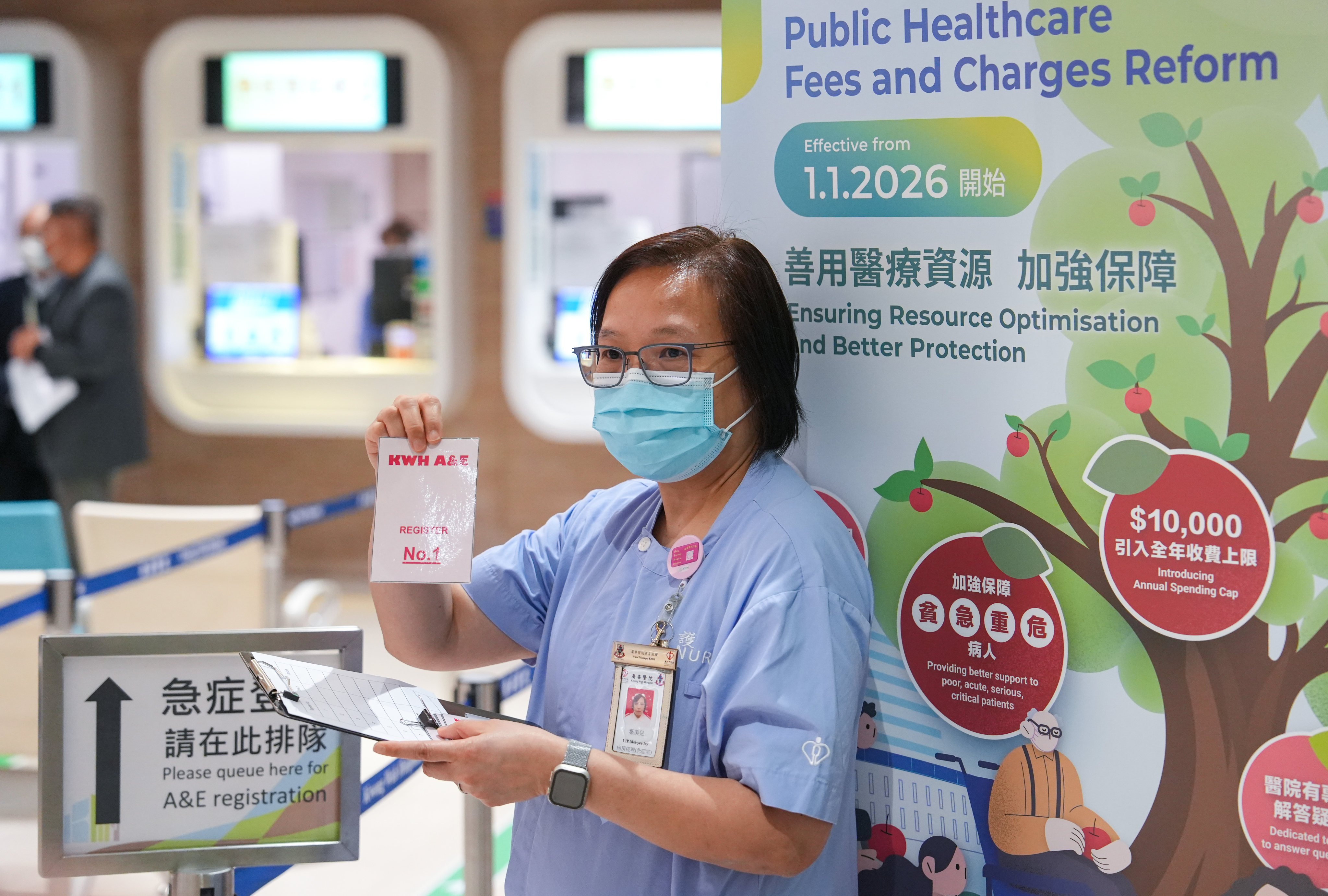 A hospital staff member holds a queue token at Kwong Wah Hospital’s A&E department on December 31, the day before the hospital fee revamp. Photo: Sun Yeung