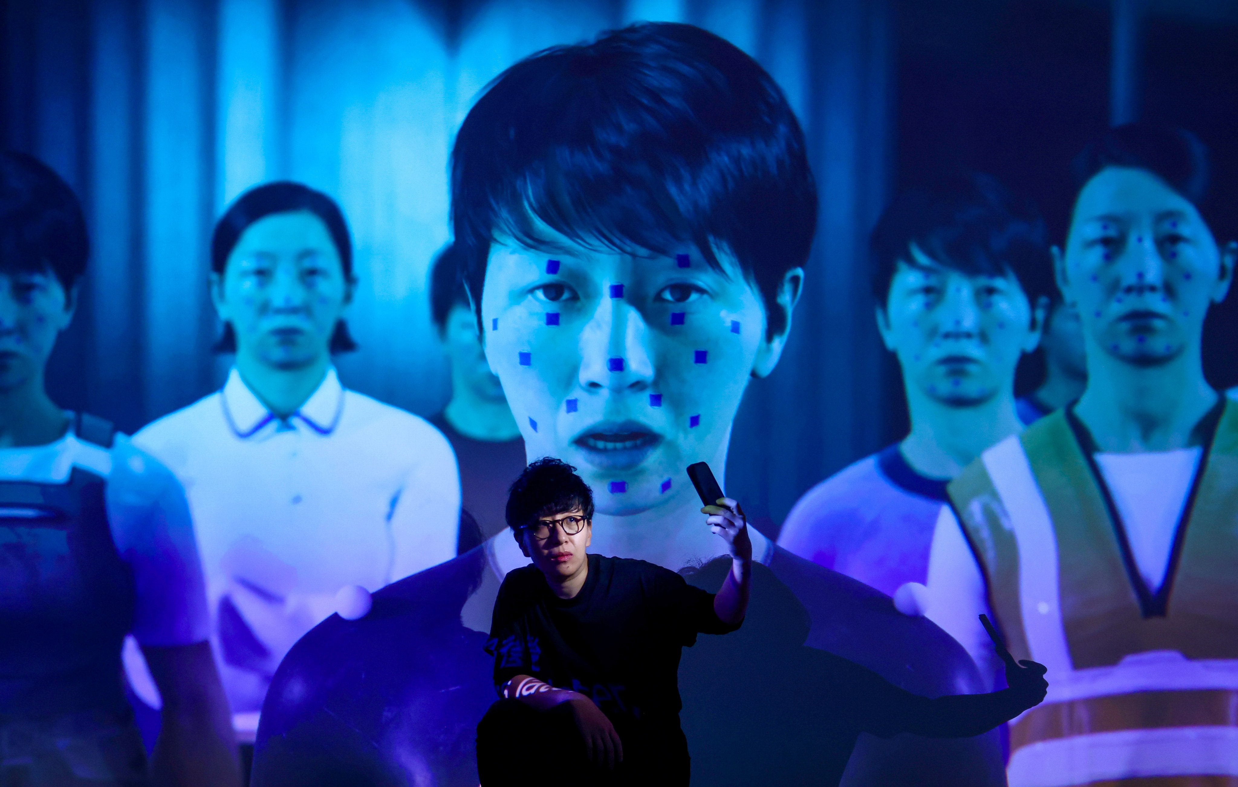 Artist Lau Wai is pictured in front of W.A.I – The Cast of the Invisible, a short film by the artist that is being screened as part of a new exhibition at the Hong Kong Design Institute. Photo: Jonathan Wong