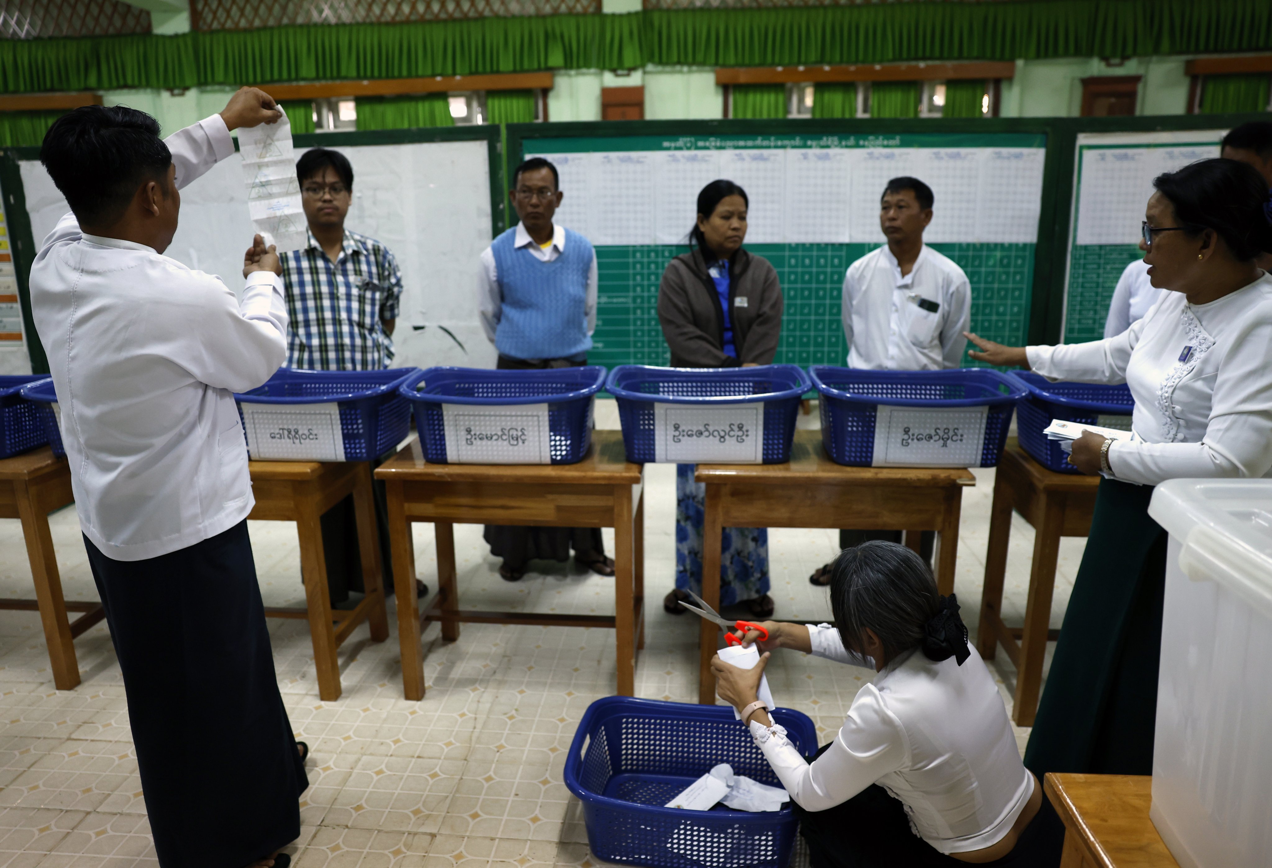 Electoral officers count early voting ballots after closing the first phase of Myanmar’s general election at a polling station in Naypyitaw, on December 28. Photo: EPA