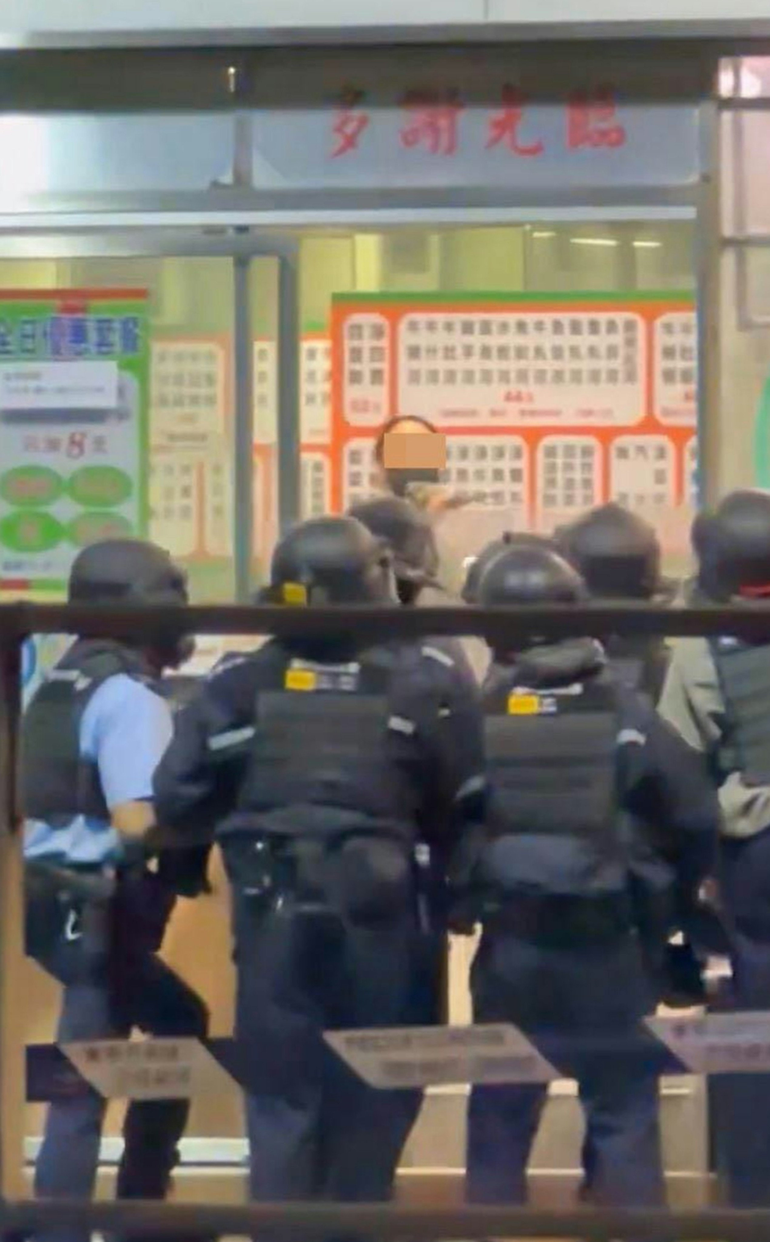 In a video that has gone viral online, the Hong Kong woman is seen brandishing the cleaver at police officers armed in riot gear. Photo: Handout