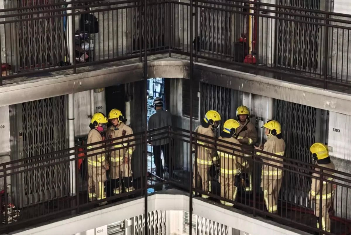 Firefighters at the scene of the blaze in Lai Yiu Estate’s Fu Yiu House on Friday morning. Photo: Handout